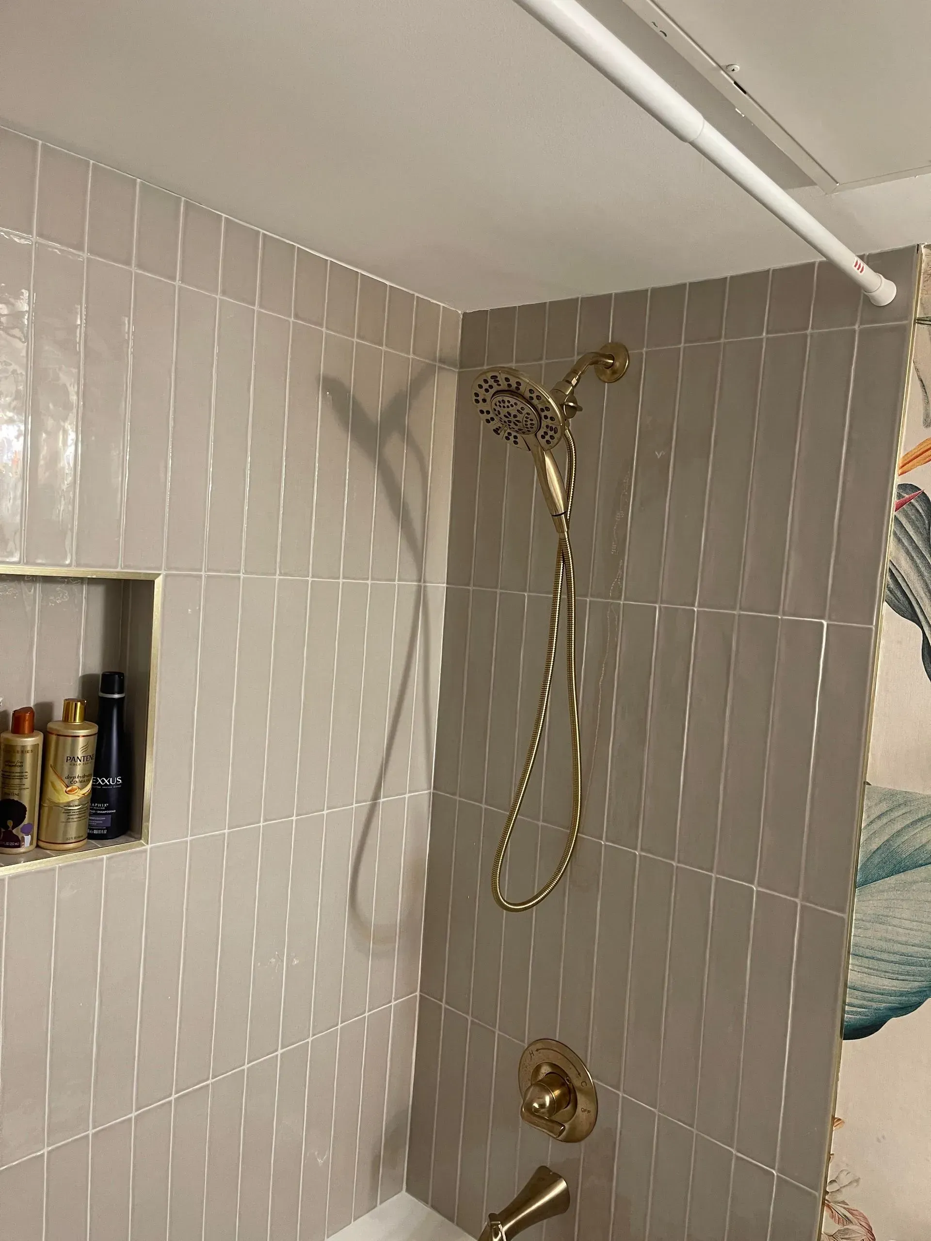 A bathroom with a shower head and a bathtub.