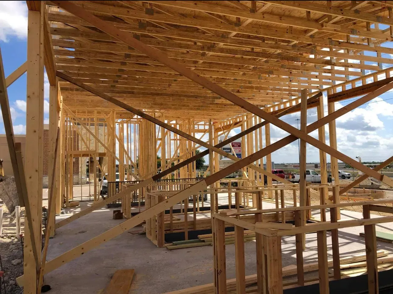 A large wooden structure is being built on a construction site.