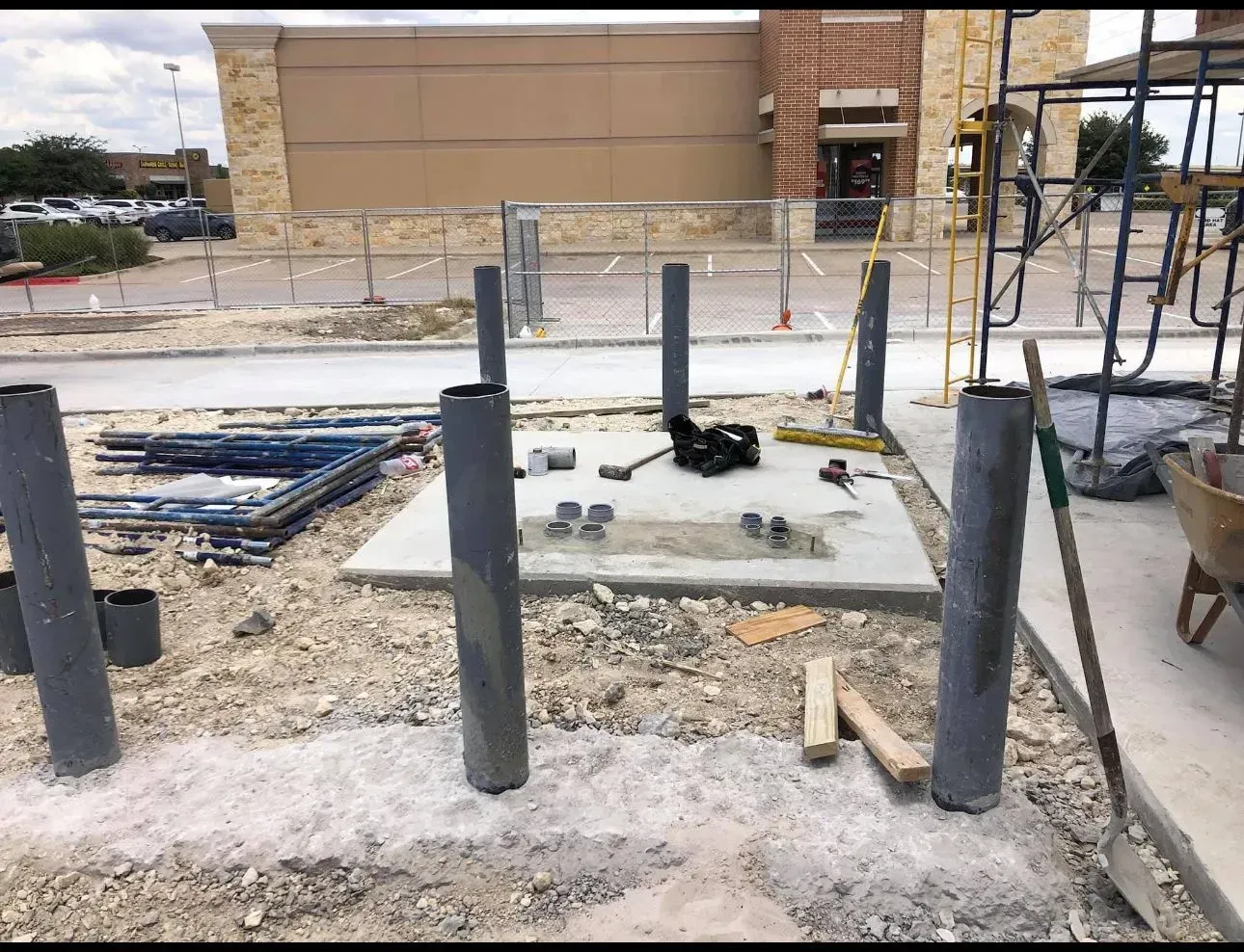 A construction site with a building in the background