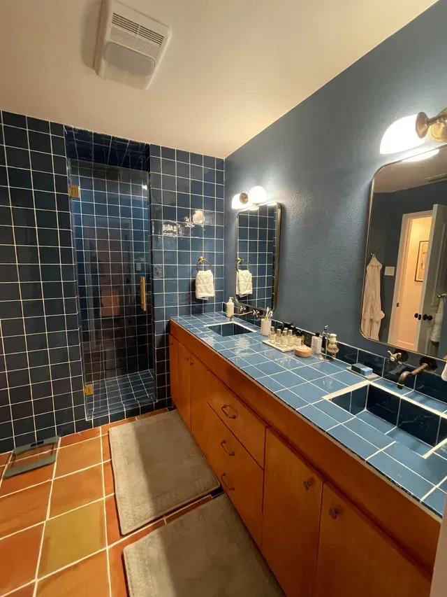 A bathroom with two sinks and a mirror