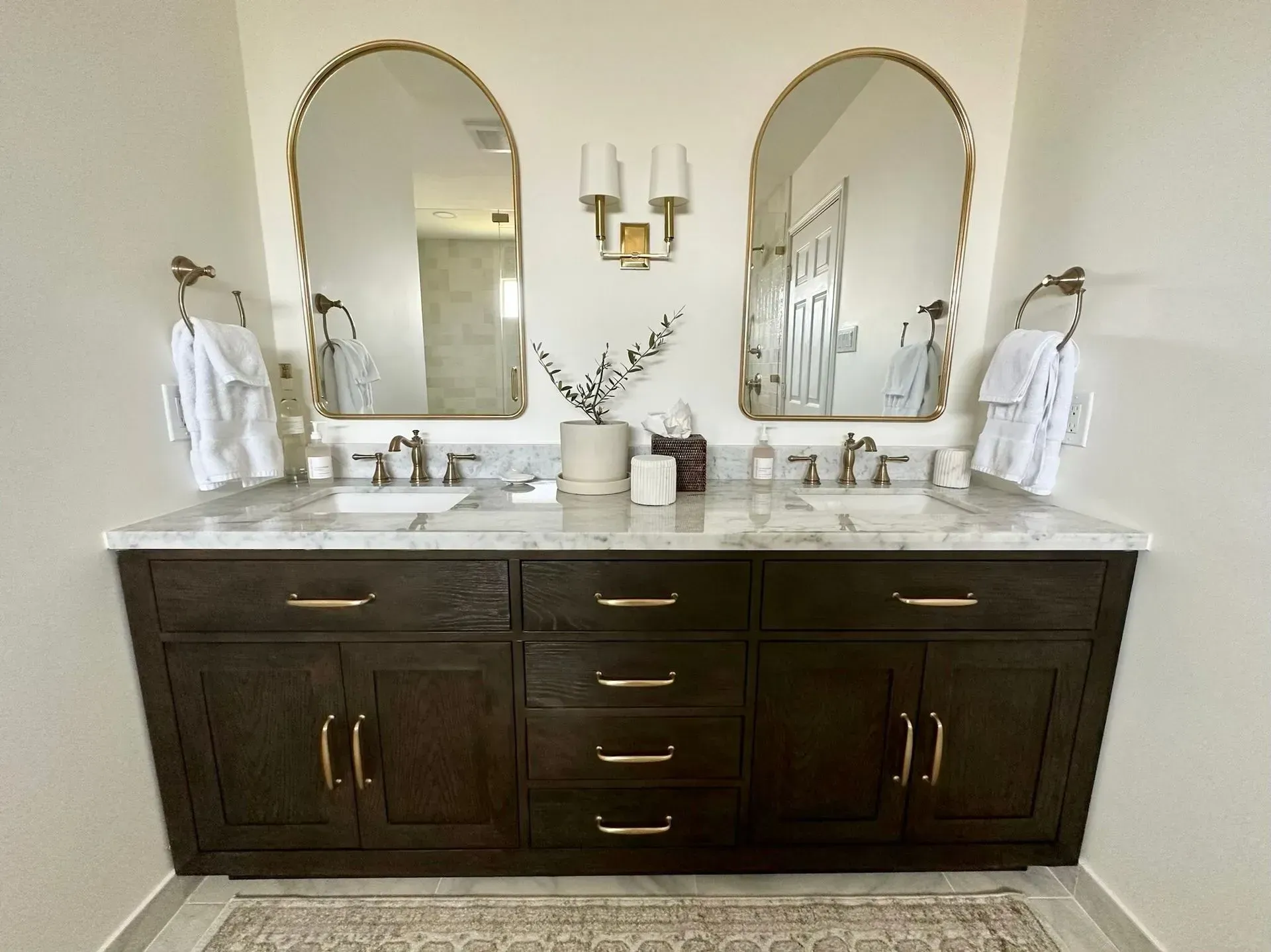 A bathroom with two sinks and two mirrors.