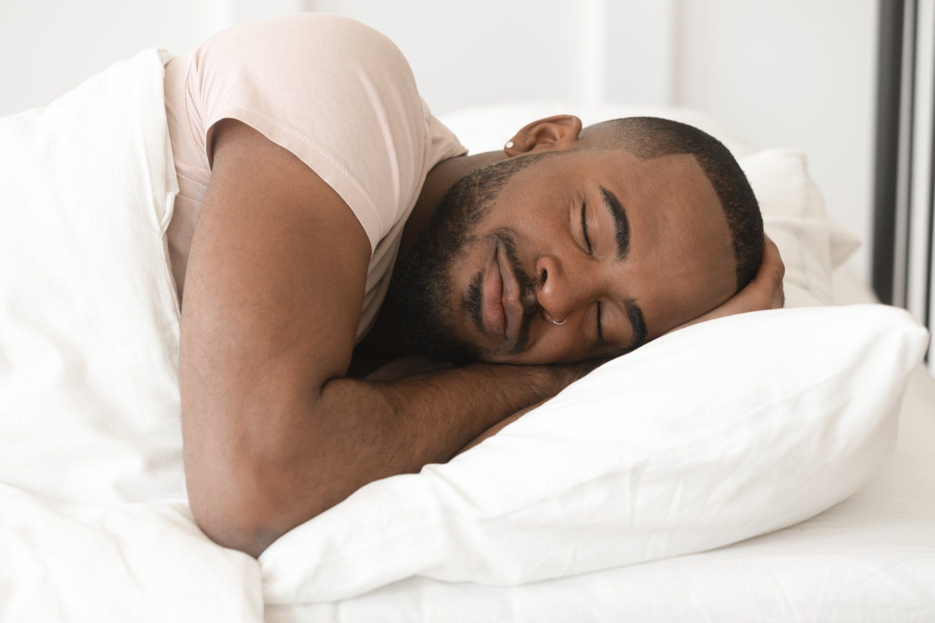 man sleeping on pillow with blanket peacefully