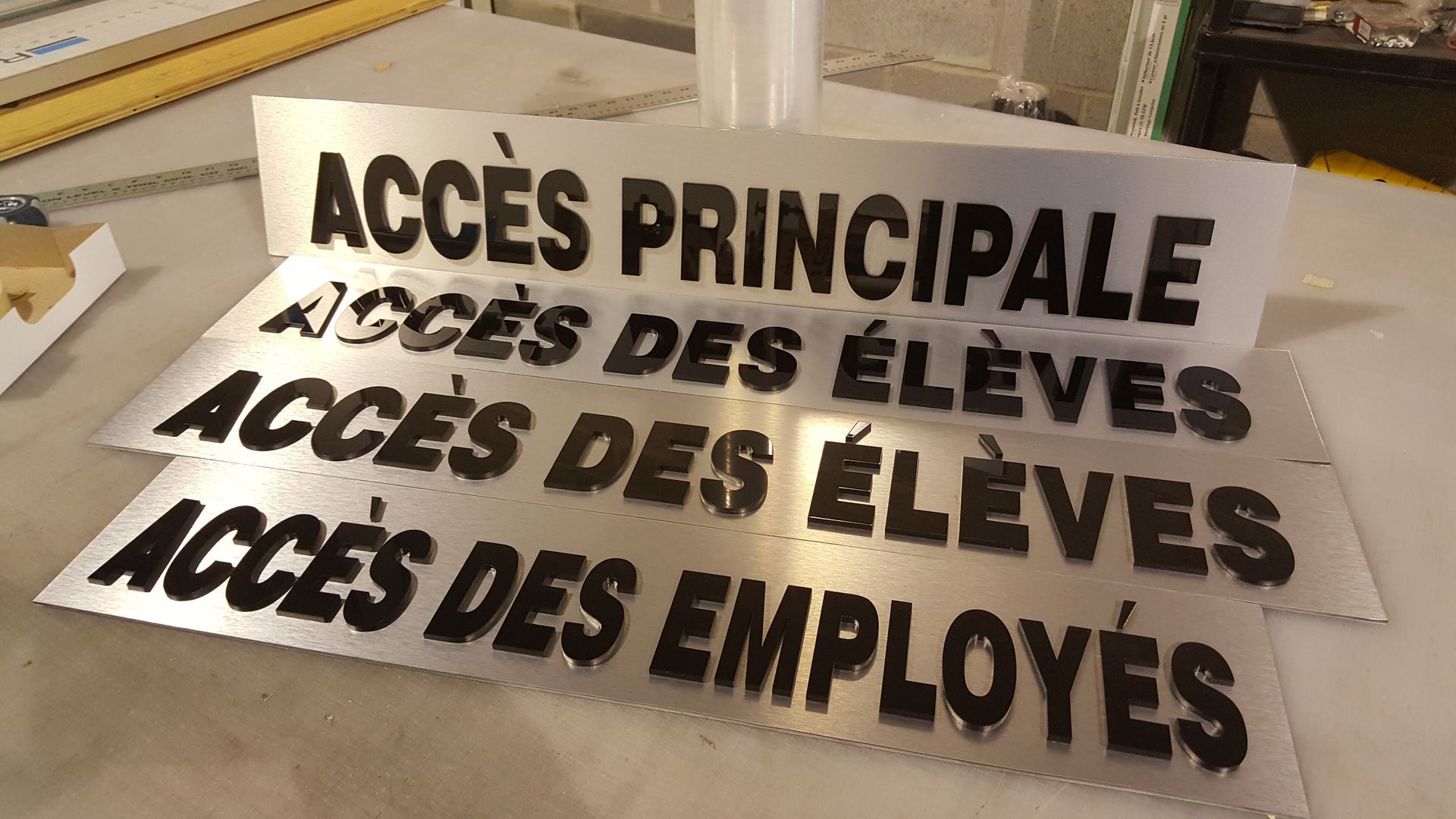 Metal signs with black text: