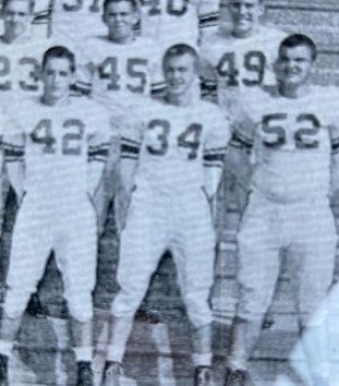 A group of football players are posing for a picture.