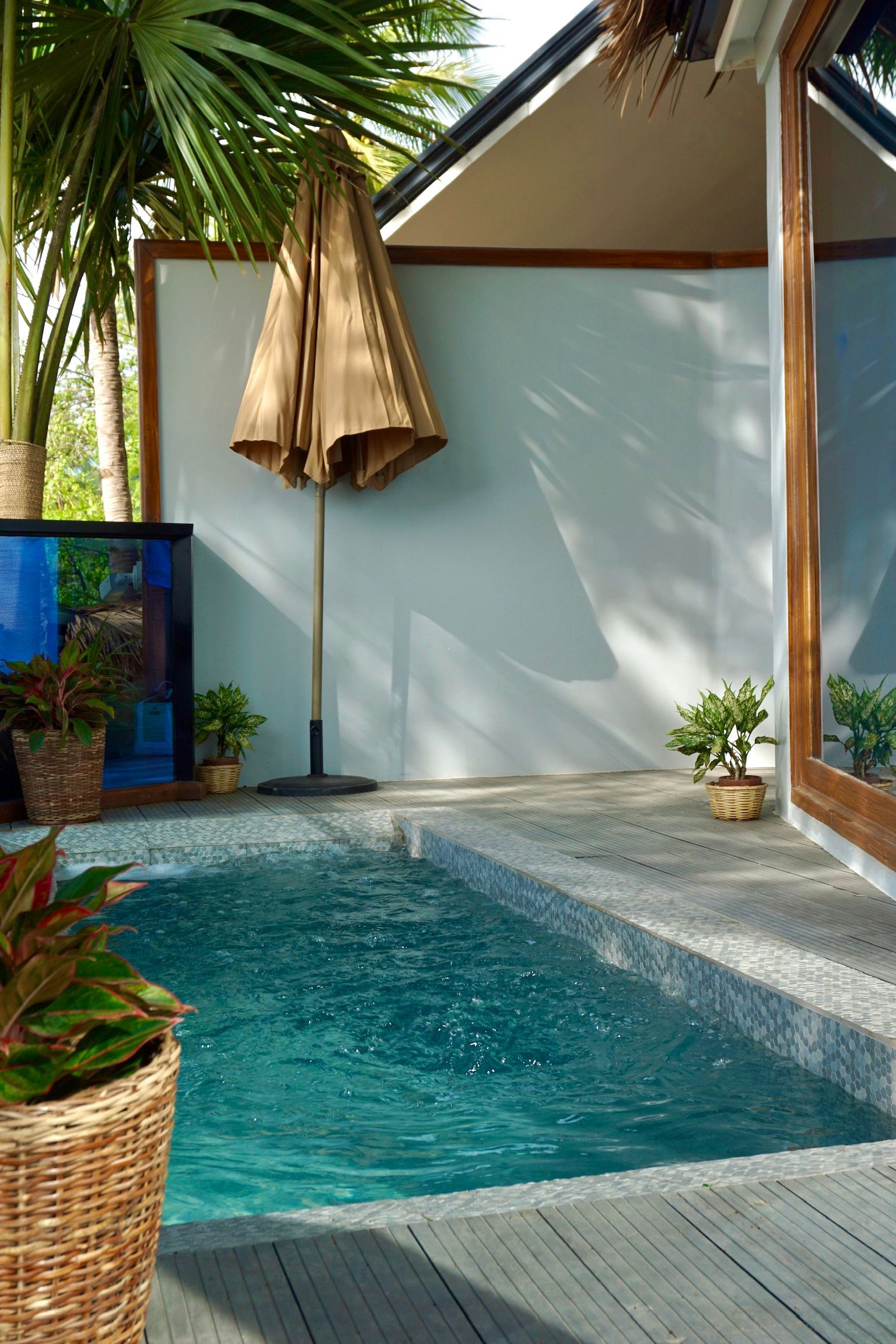A swimming pool with a wicker basket in front of it