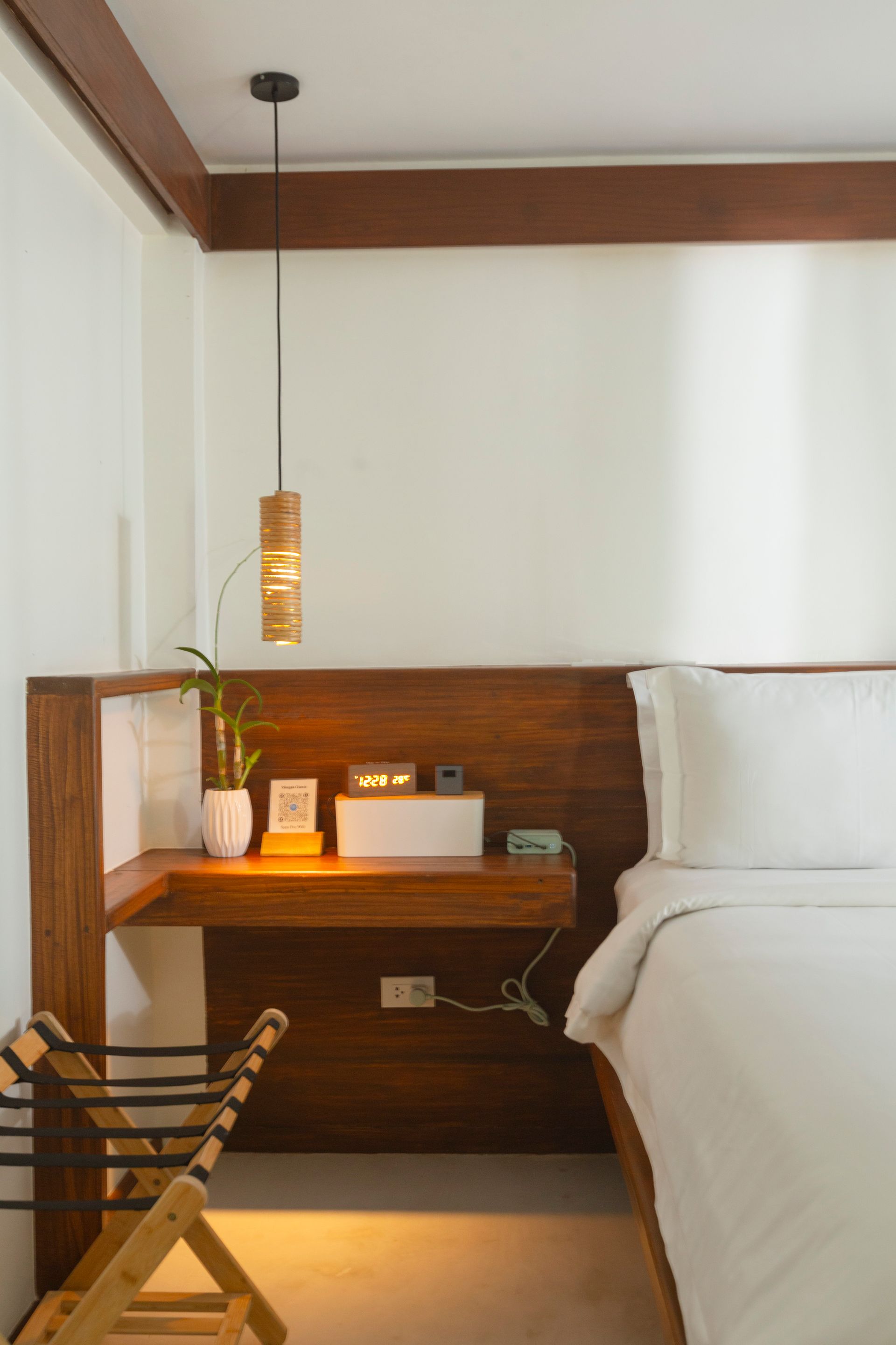 A hotel room with a bed , desk and chair.