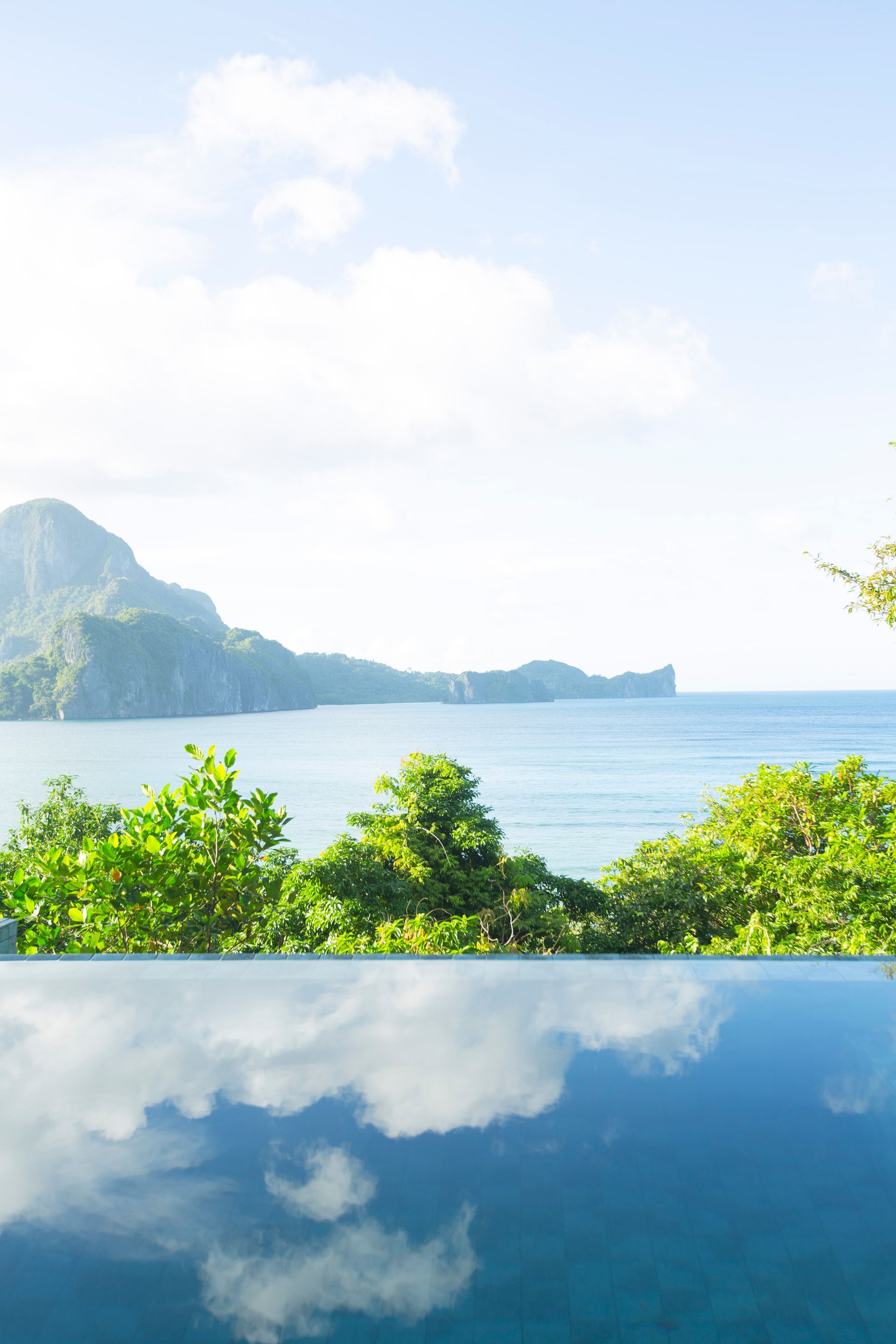 A swimming pool with a view of the ocean and mountains