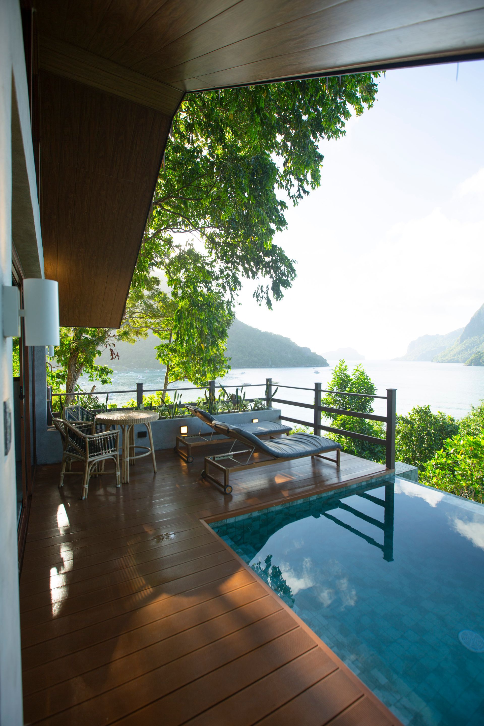 A balcony overlooking a swimming pool with a view of the ocean