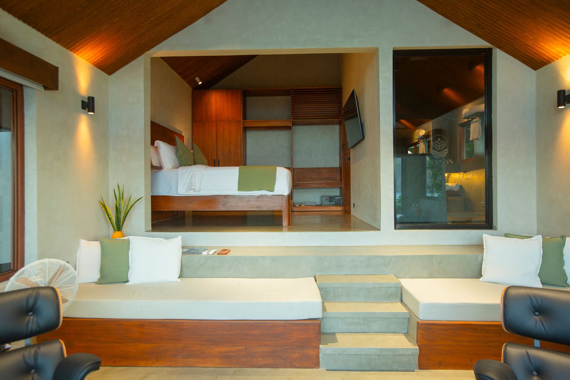 A bedroom with a bed and a couch in it