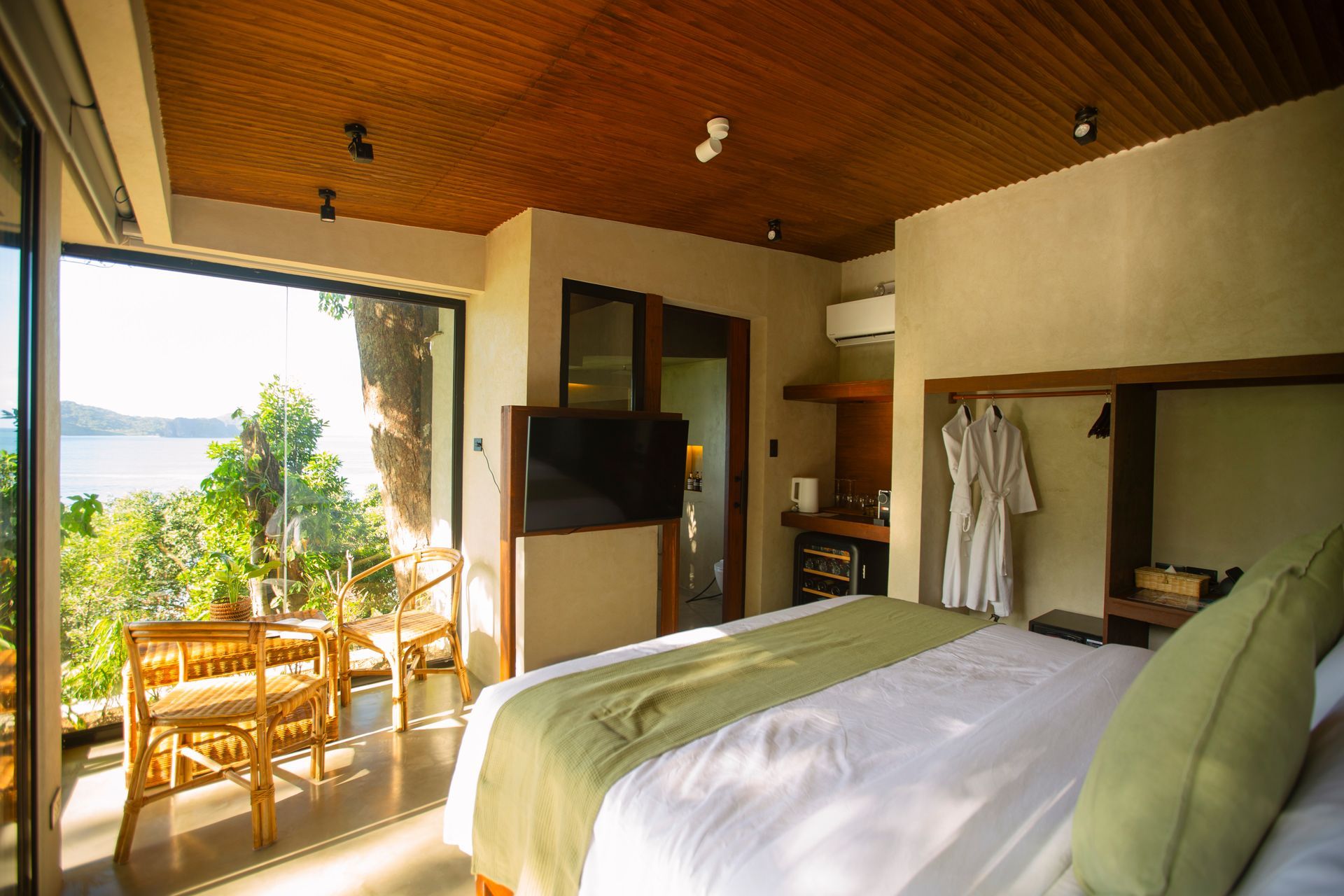 A hotel room with a large bed and a flat screen tv