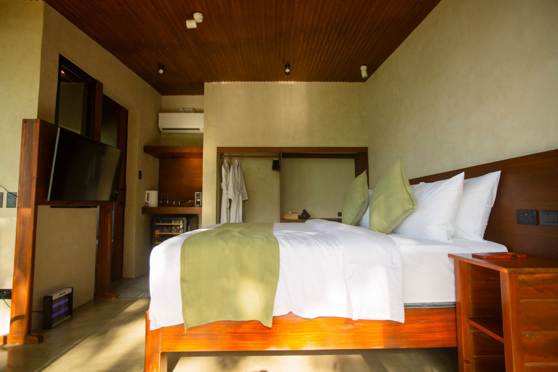A hotel room with a large bed and a television.