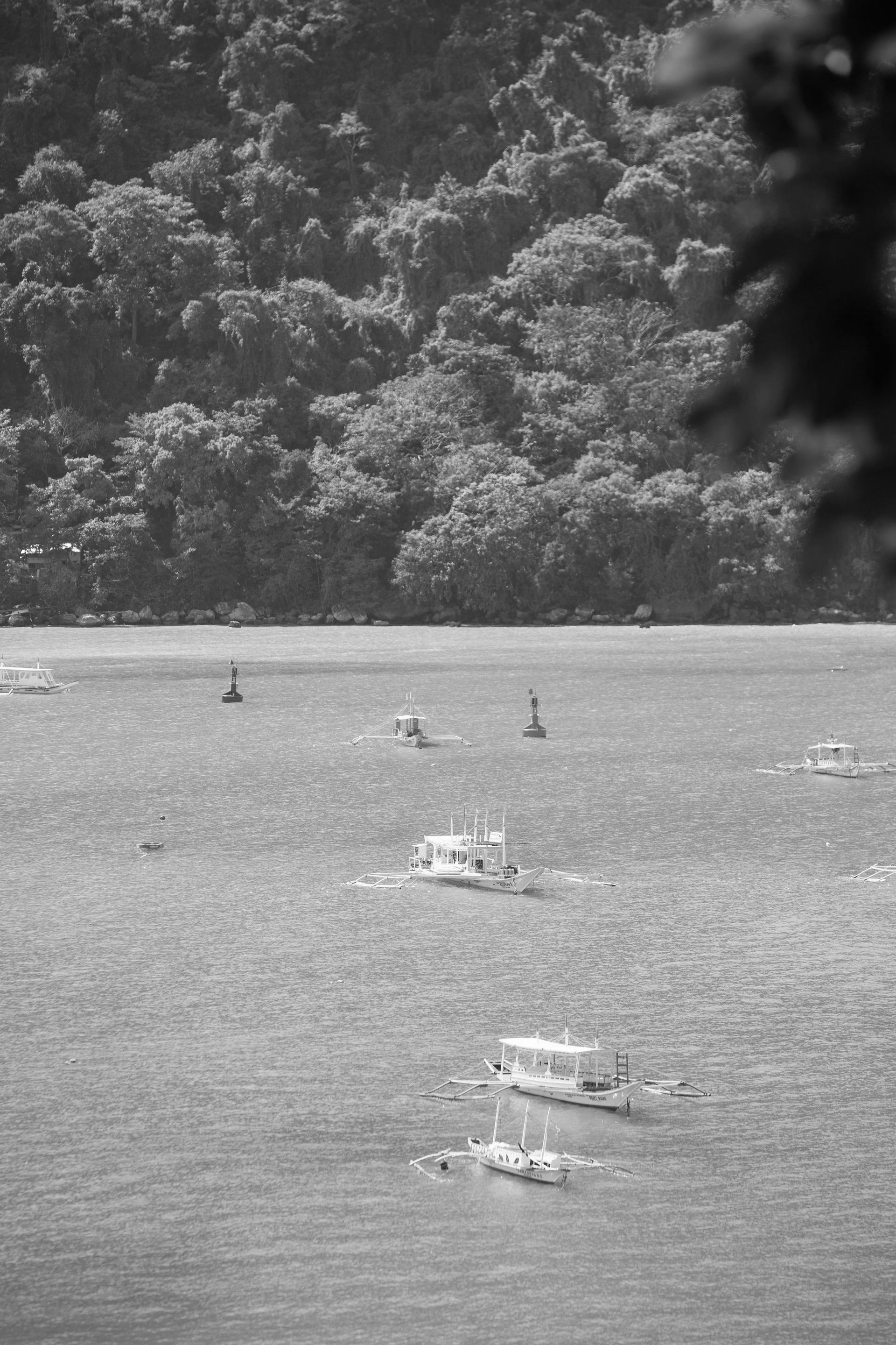 A black and white photo of boats in the water