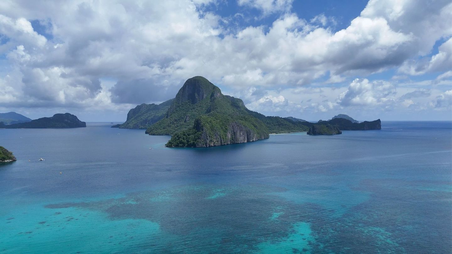 An aerial view of a tropical island in the middle of the ocean.