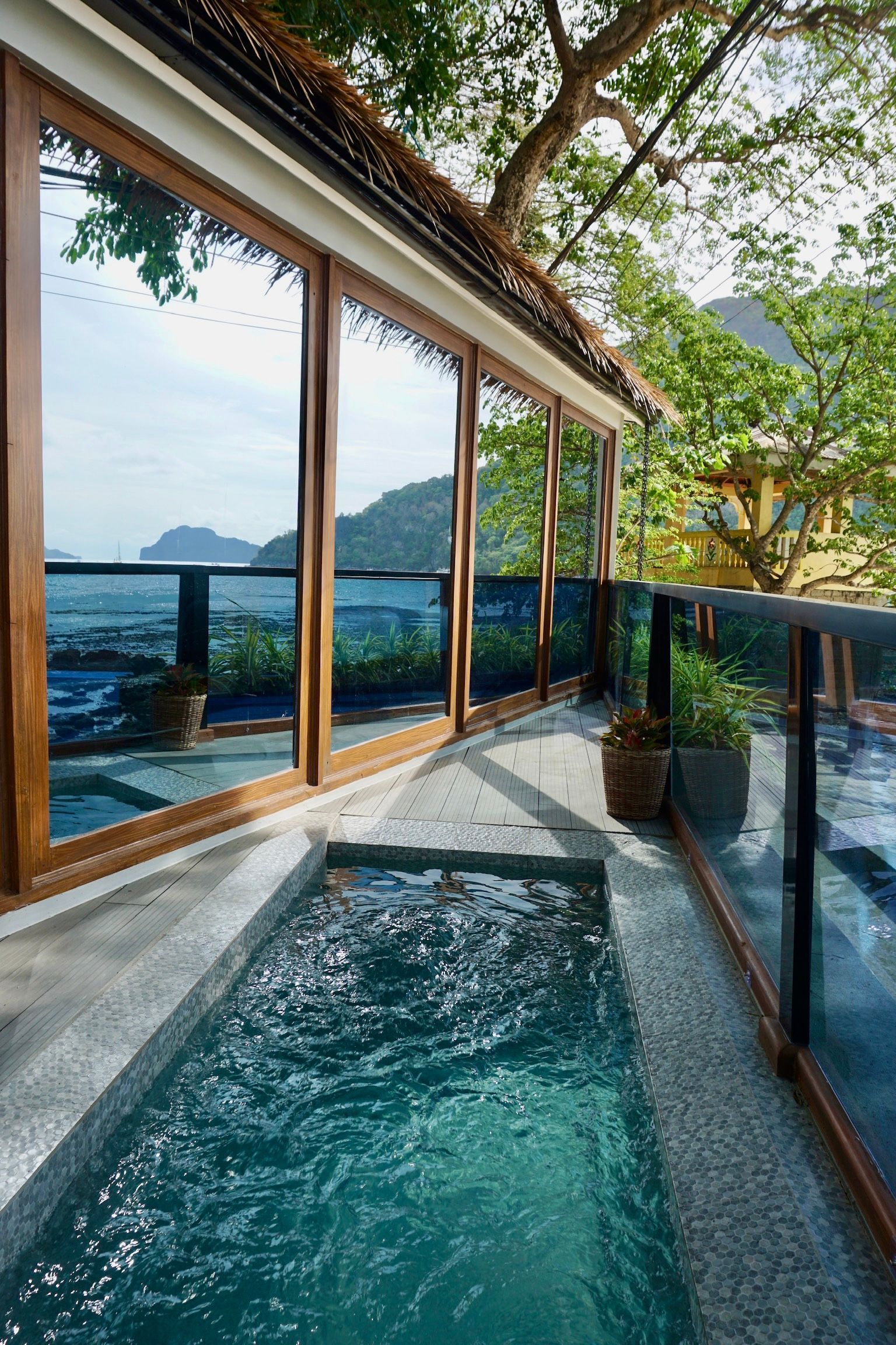 A swimming pool on a balcony with a view of the ocean.