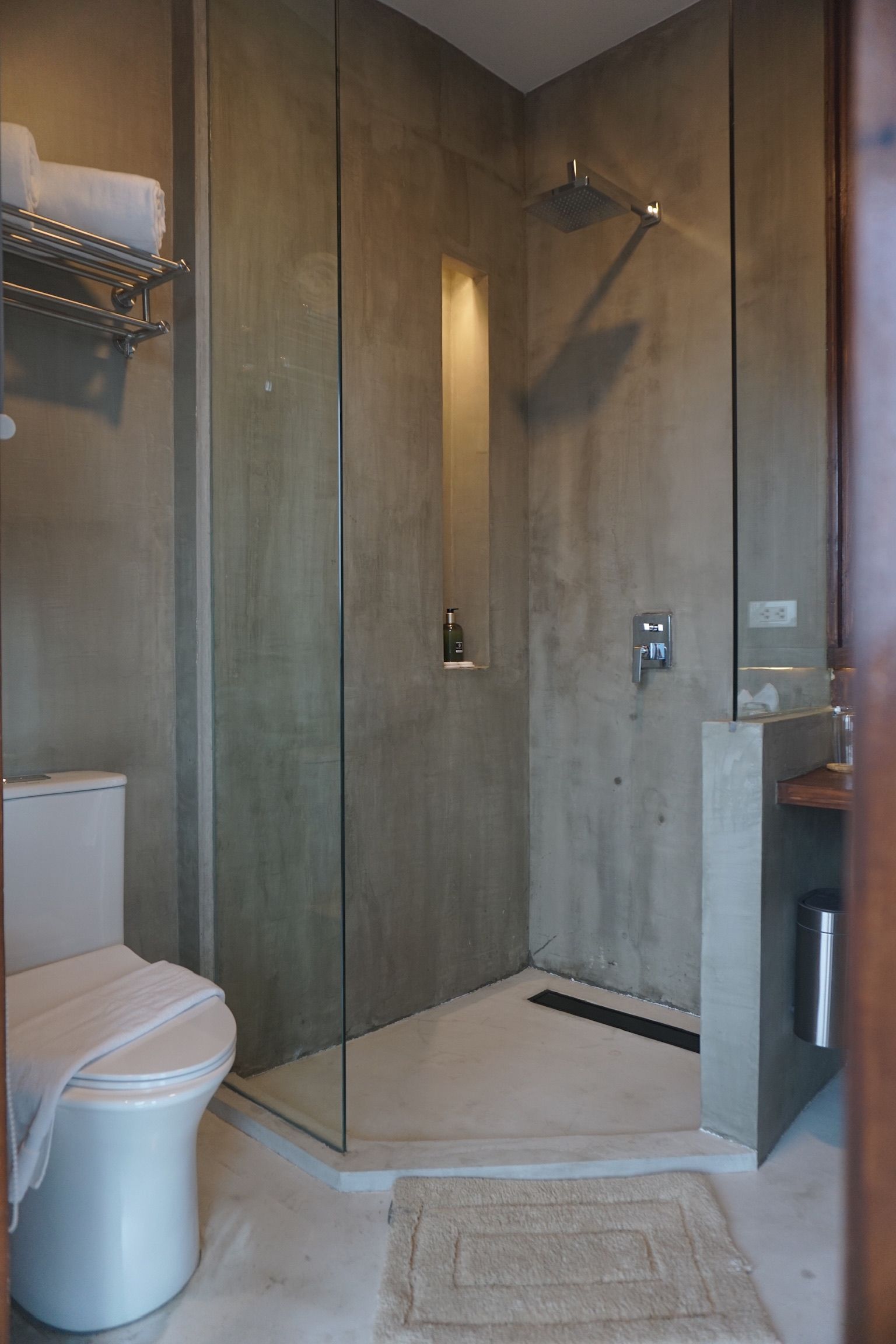 A bathroom with a toilet and a walk in shower.