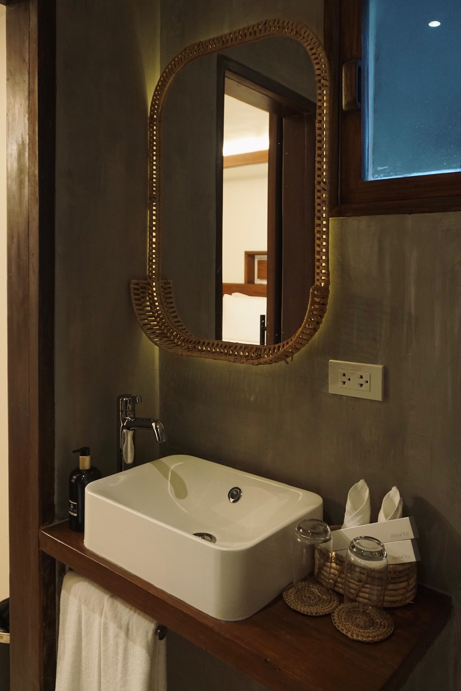 A bathroom with a sink and a mirror on the wall.
