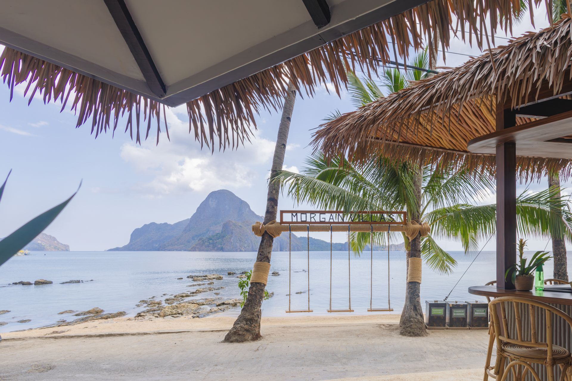A thatched hut on a beach overlooking the ocean