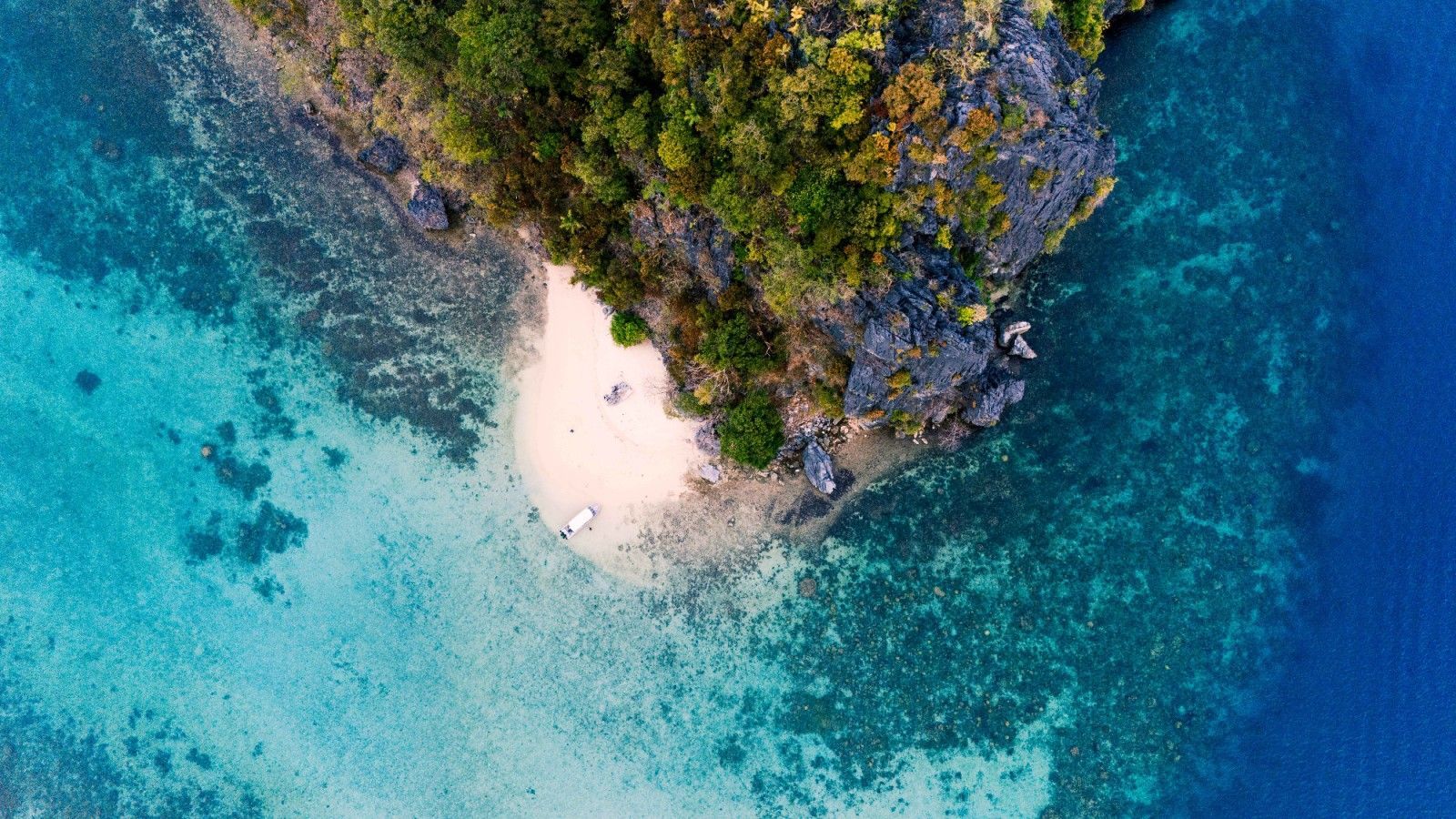 An aerial view of a small island in the middle of the ocean.