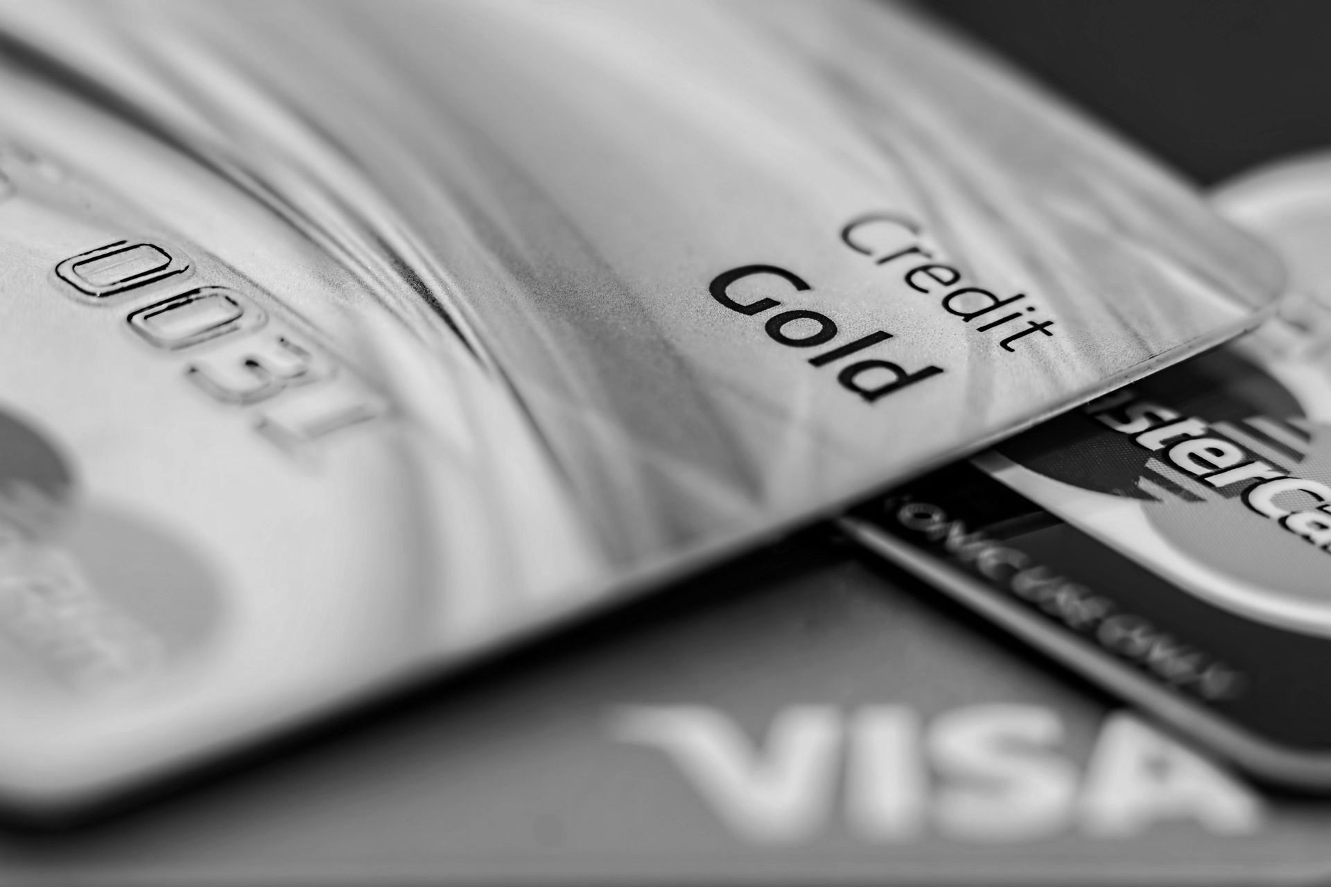 A black and white photo of a credit card and a visa card
