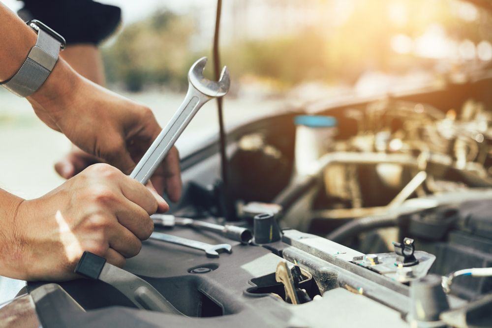 Mechanic Holding A Wrench — South Lyon, MI — Norm’s Total Automotive