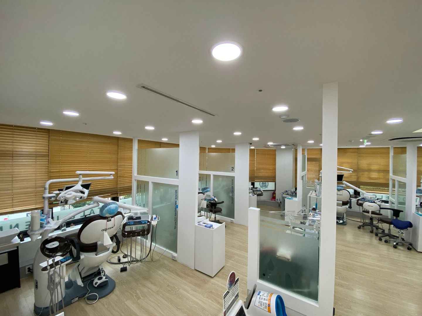 A dental office with a lot of dental chairs and instruments.