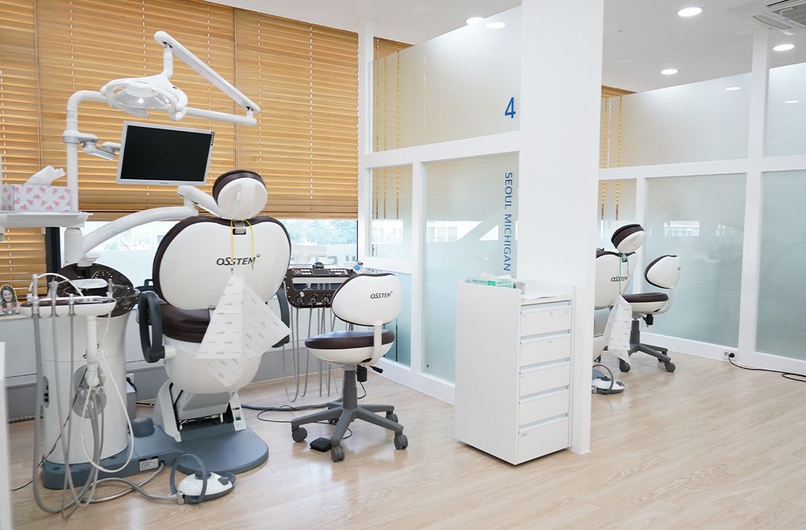 There is a dental chair in the middle of the room.