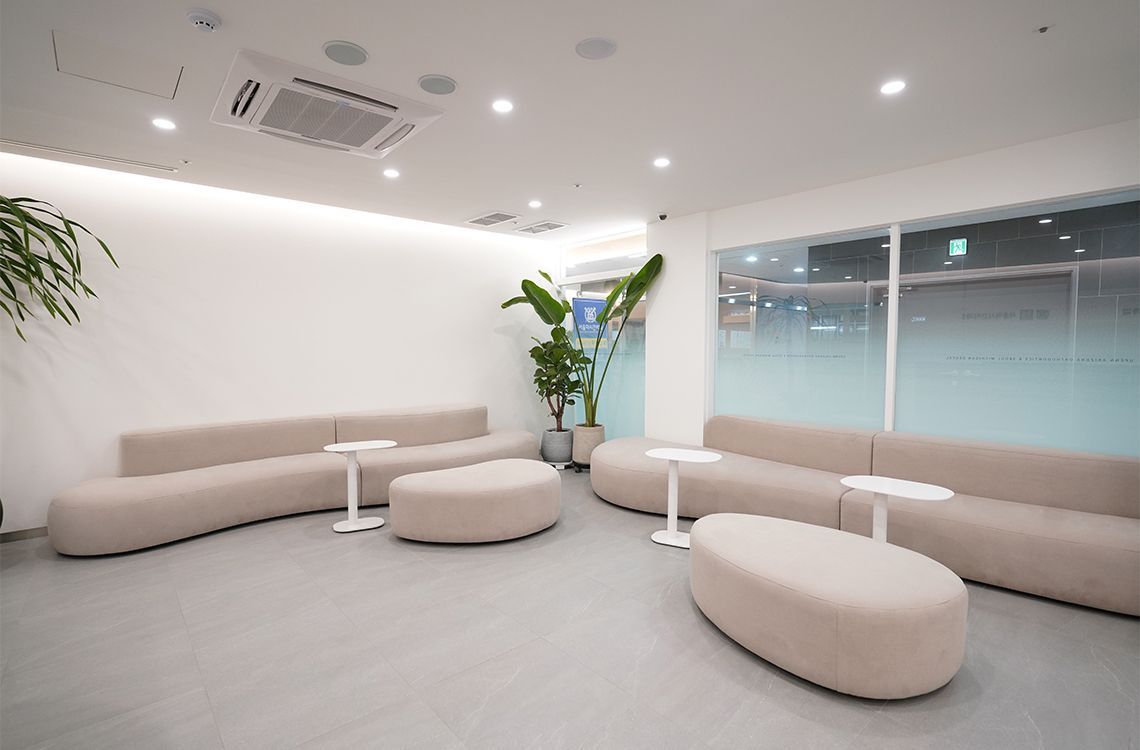 A waiting room with a lot of furniture and tables.