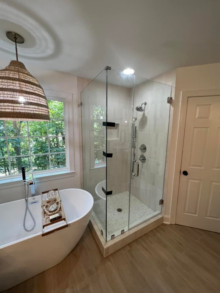 Modern bathroom with a glass shower, soaking tub, and natural light.