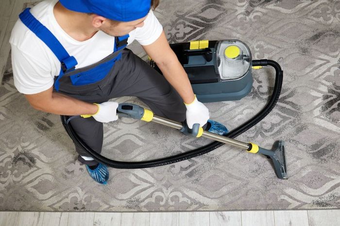 A top view image featuring a cleaning company worker in a specialized uniform and protective gear.