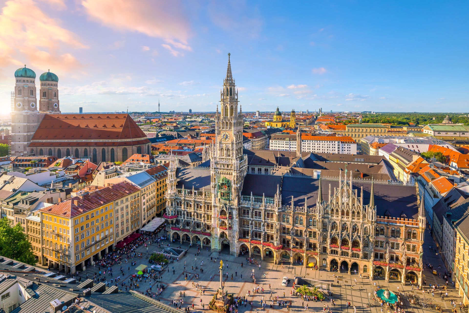 An aerial view of a city with a clock tower in the middle of it.