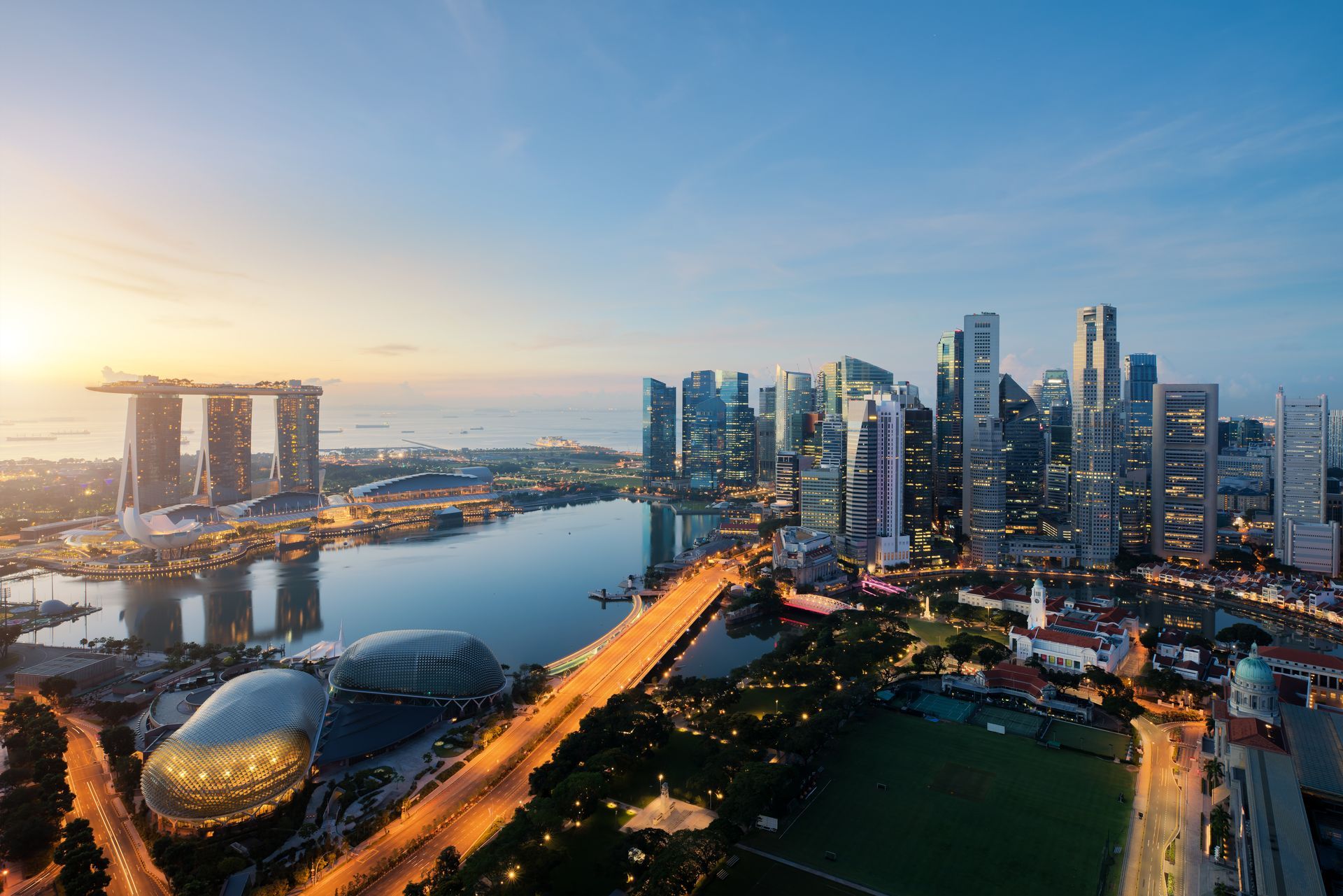 An aerial view of a city skyline at sunset.
