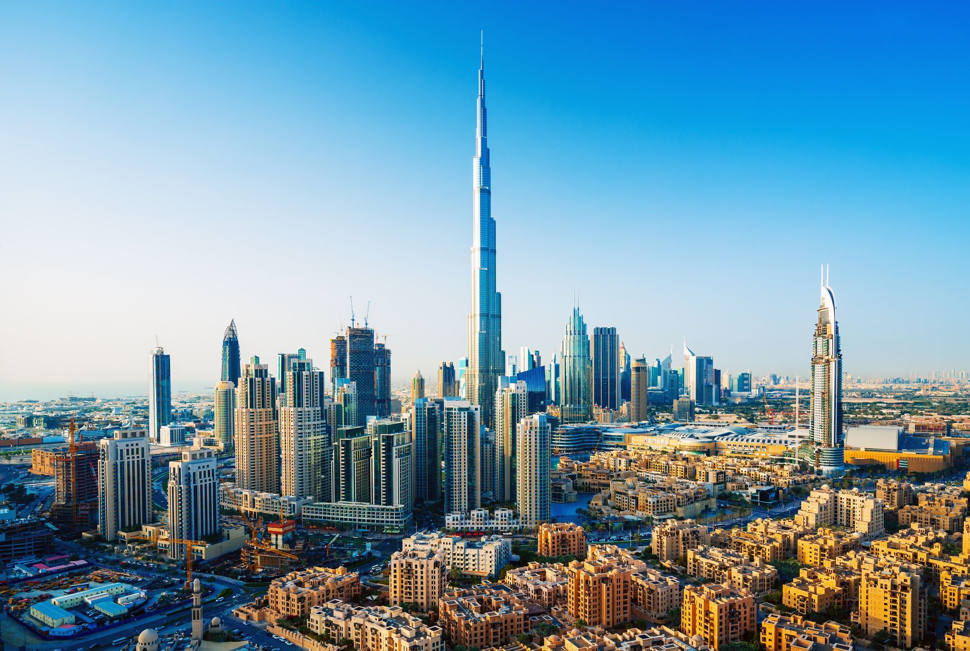 An aerial view of the skyline of dubai with the tallest building in the middle of the city.