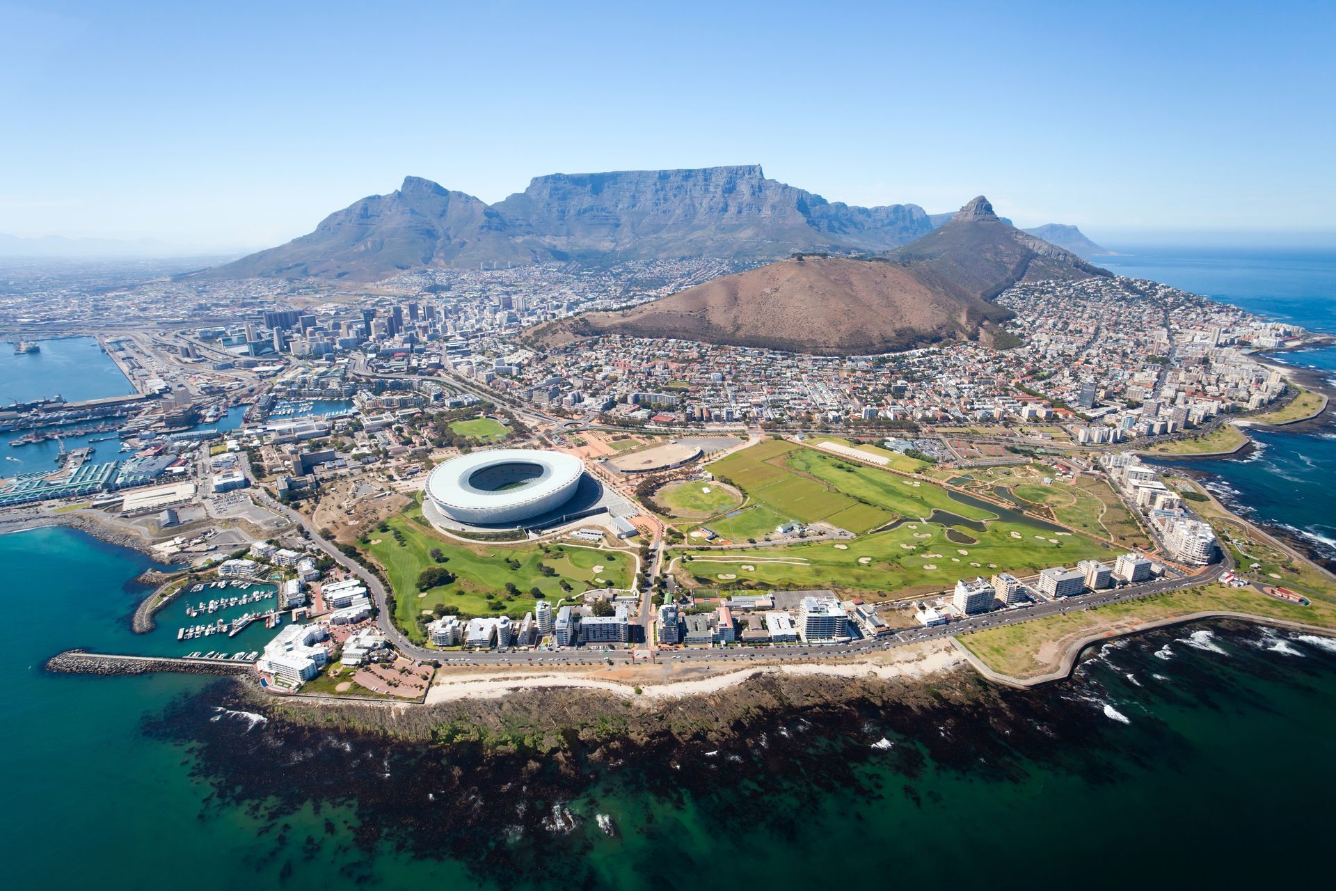 An aerial view of cape town with a mountain in the background.