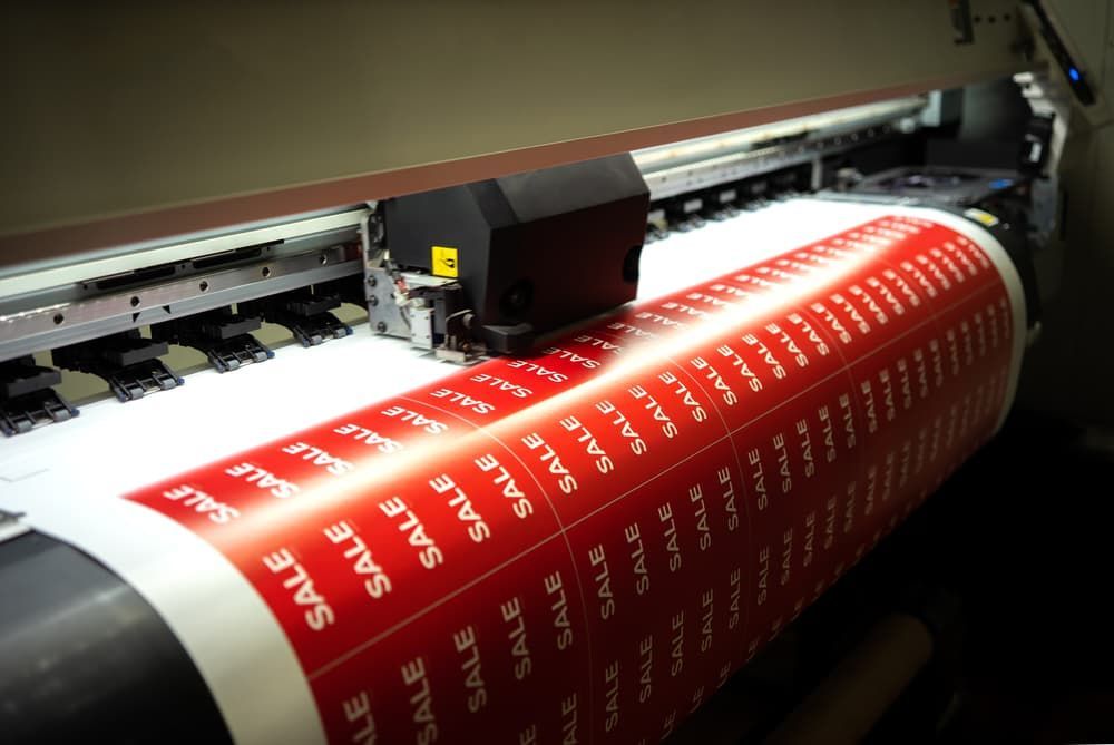 A Large Sheet of Paper Is Being Printed with The Word Sale on It — Brookes Engraving & Signs in Woonona, NSW