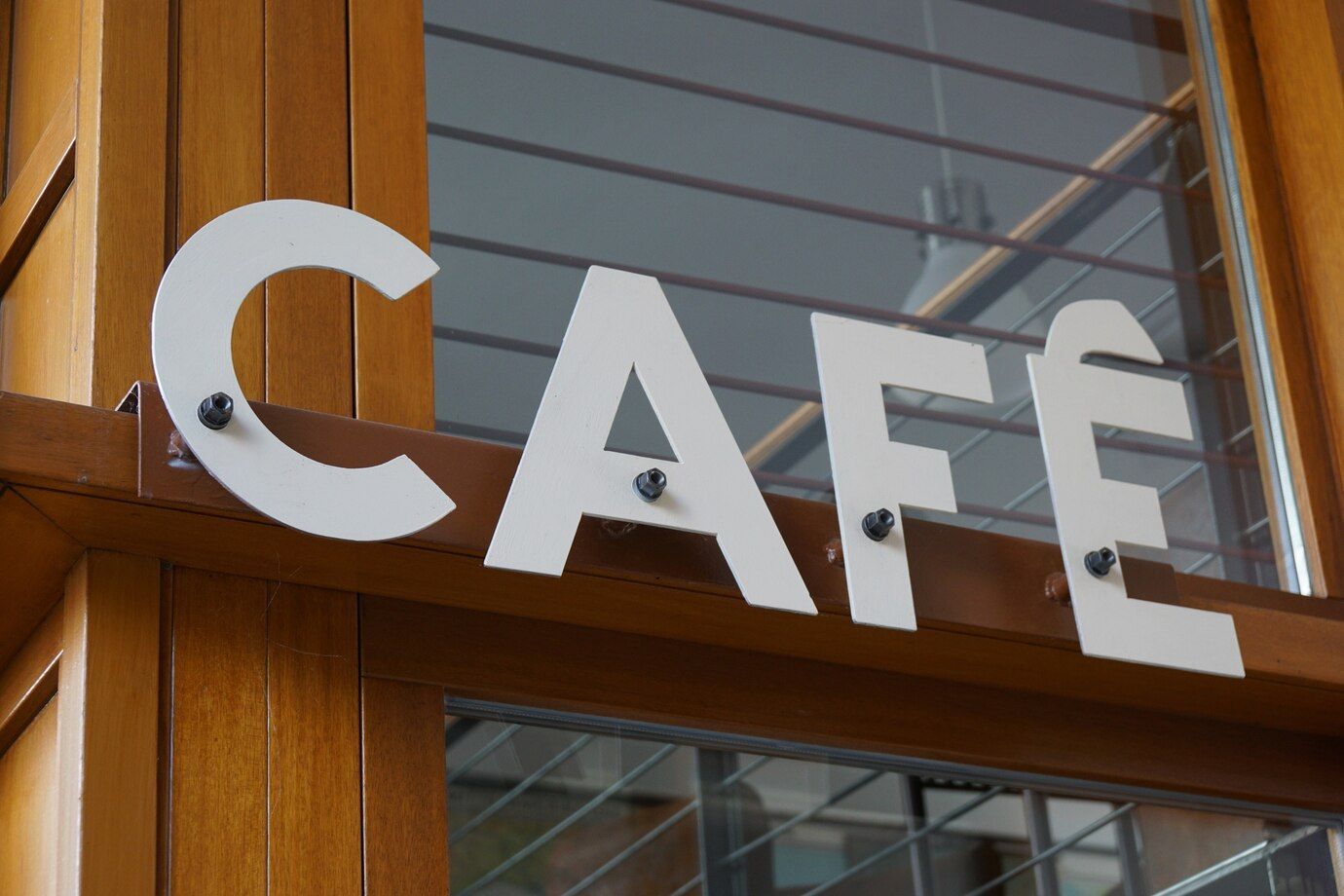 The Word Cafe is on a Wooden sign — Brookes Engraving & Signs in Wollongong, NSW