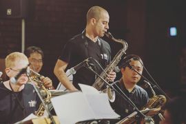Saxophone players performing on stage with microphones.