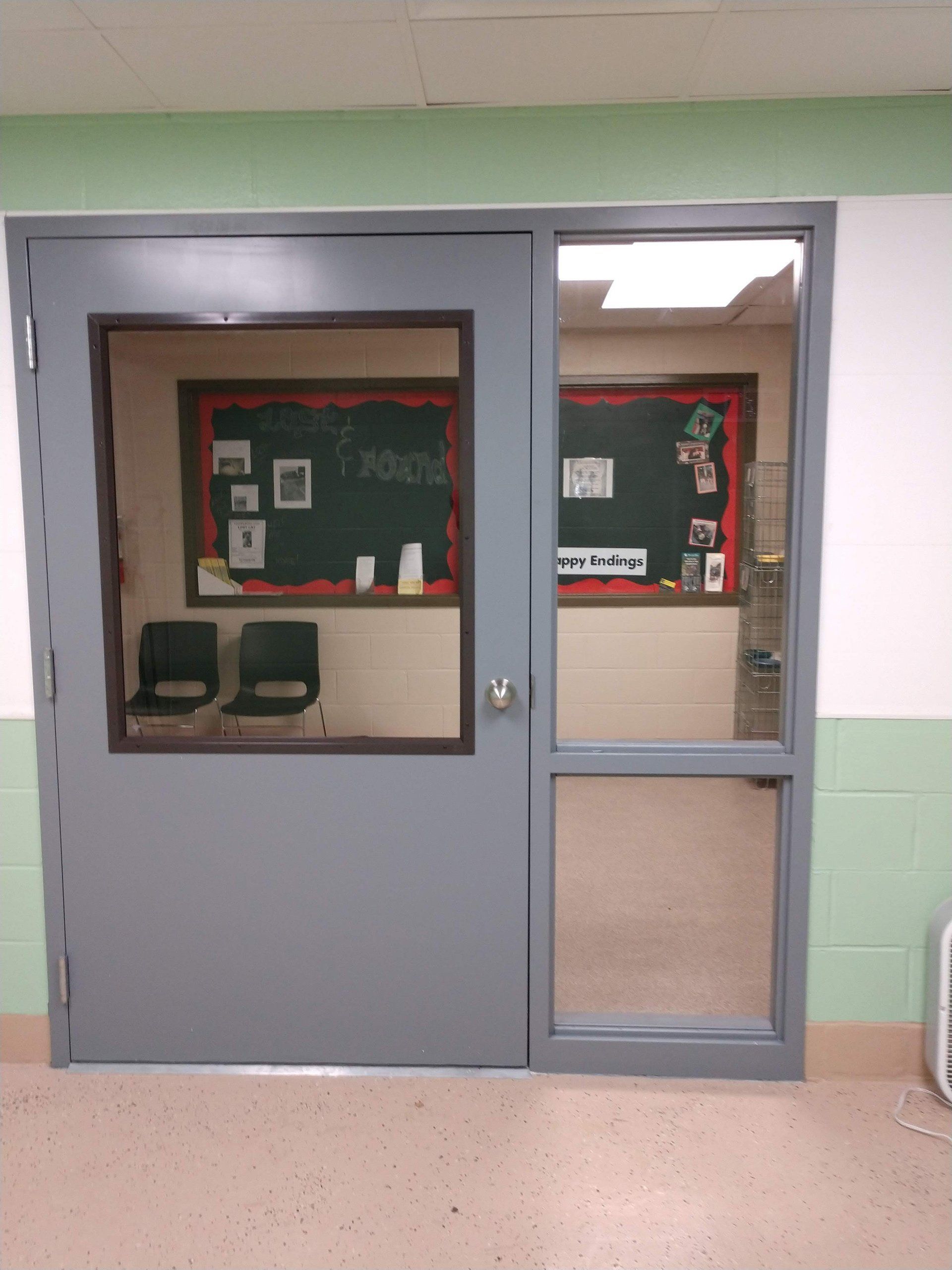 Fiberglass doors in a school with extra windows to the side.
