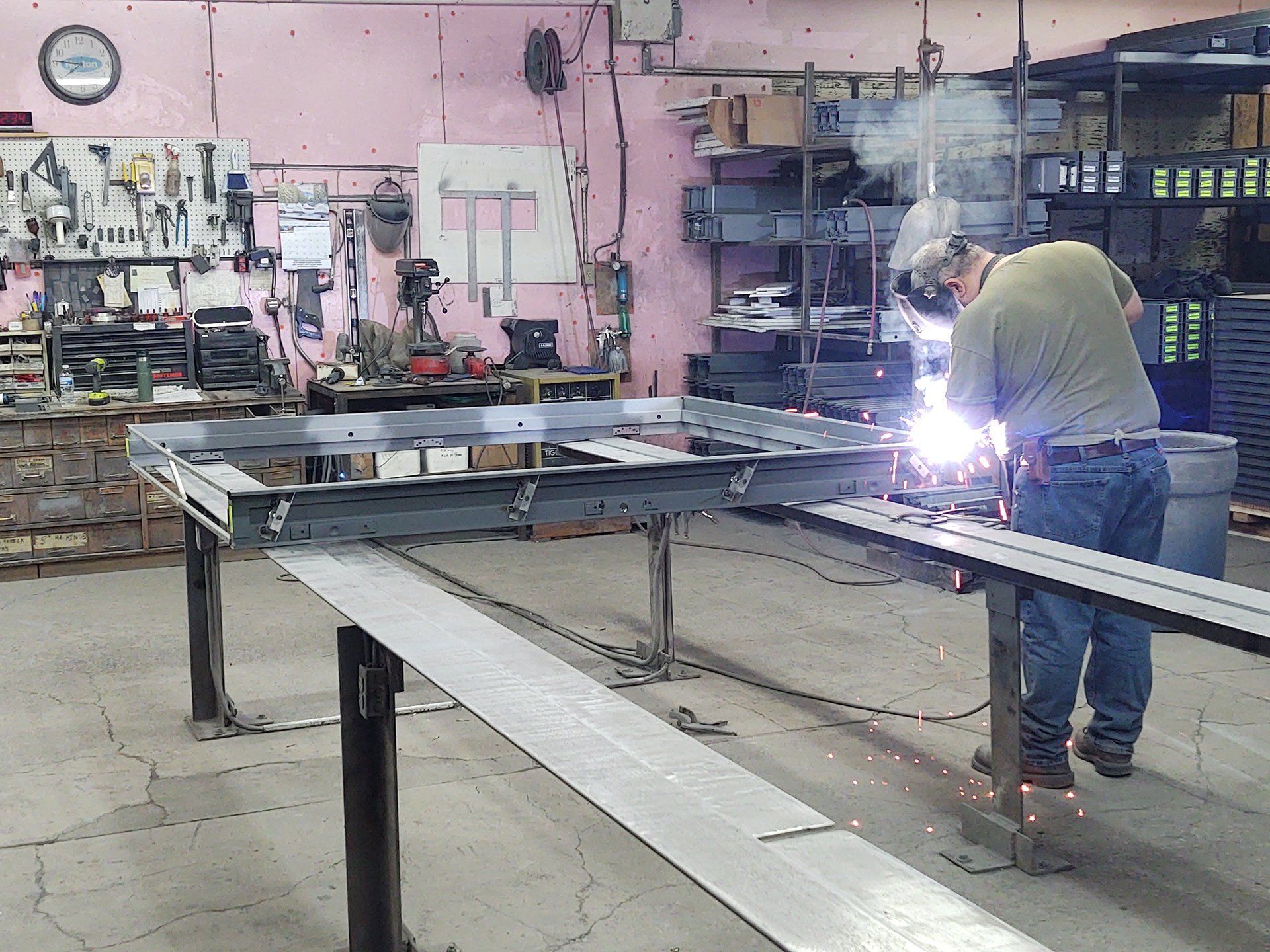 Man working on a door frame with protective gear on.