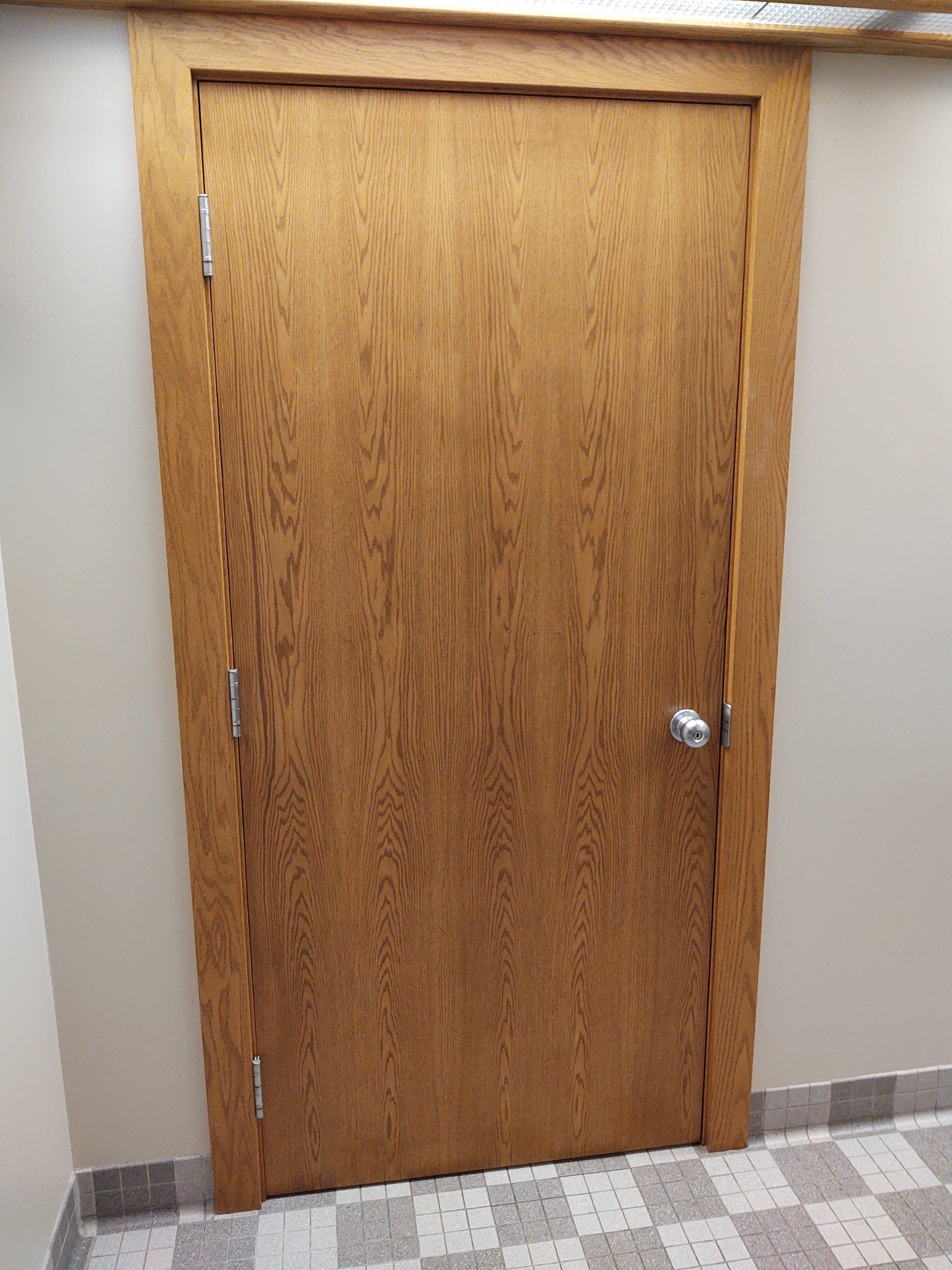Wooden Door in hallway.