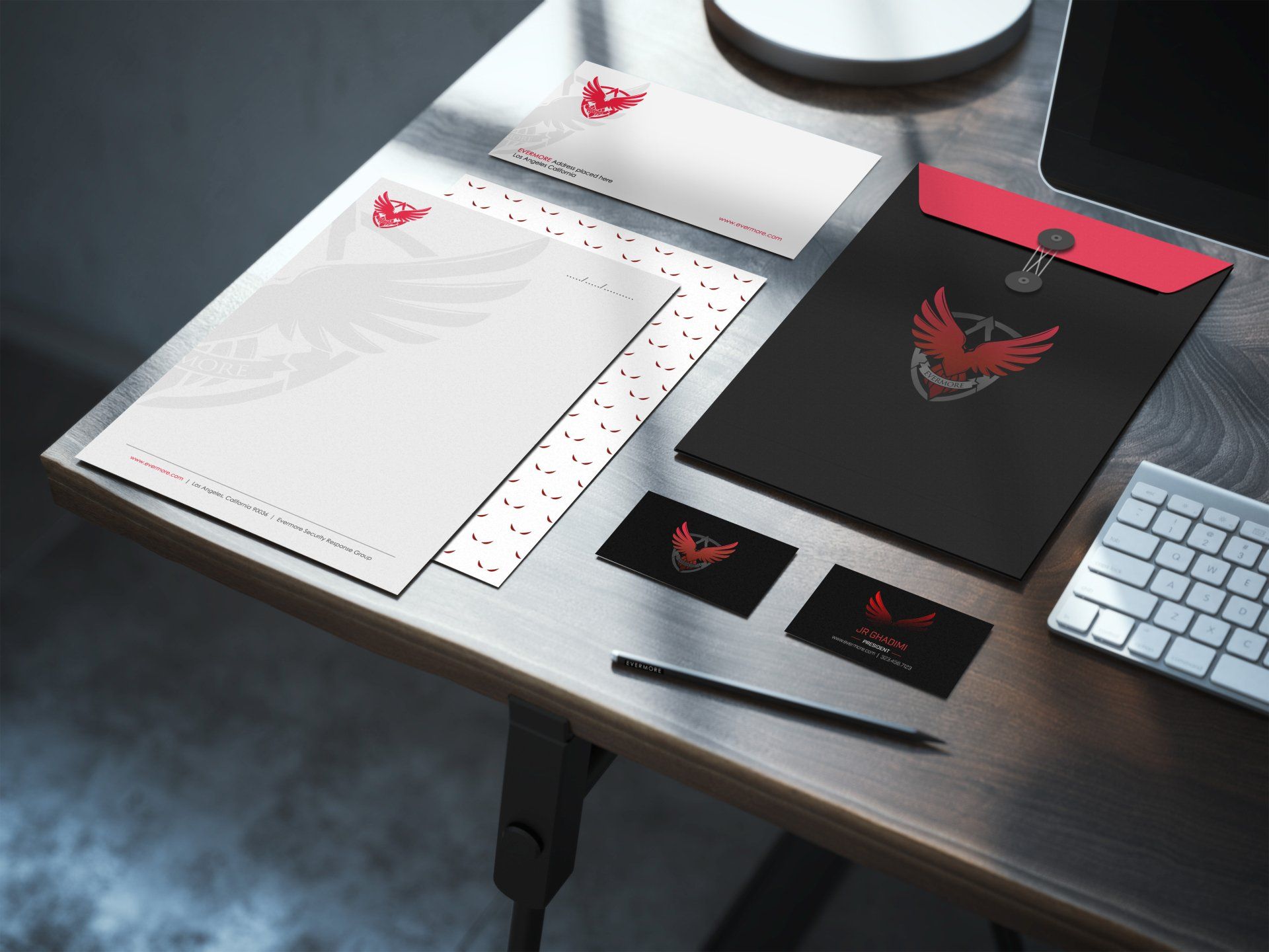 a desk with a computer and a pen on it