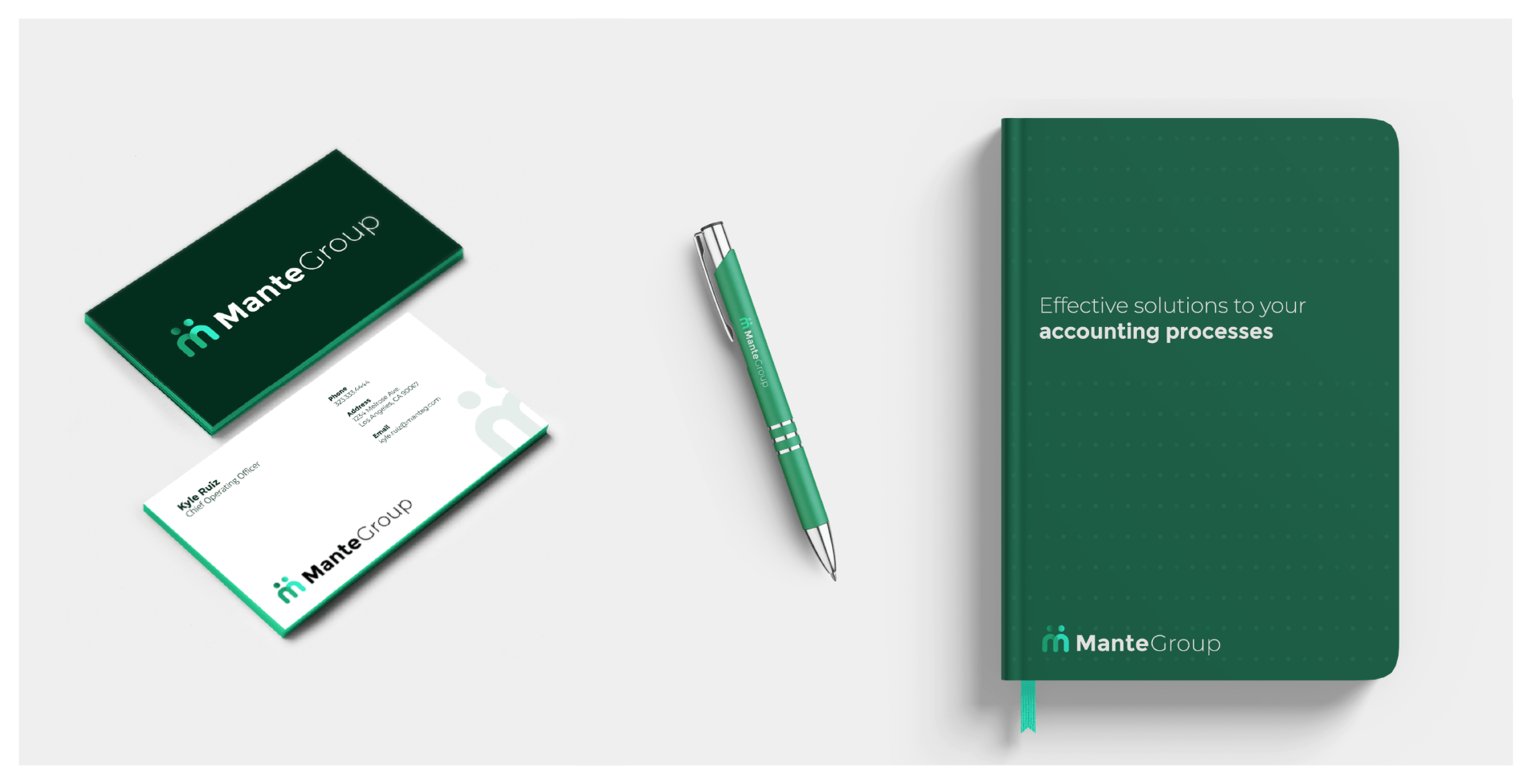 a business card , pen , and notebook are on a table .