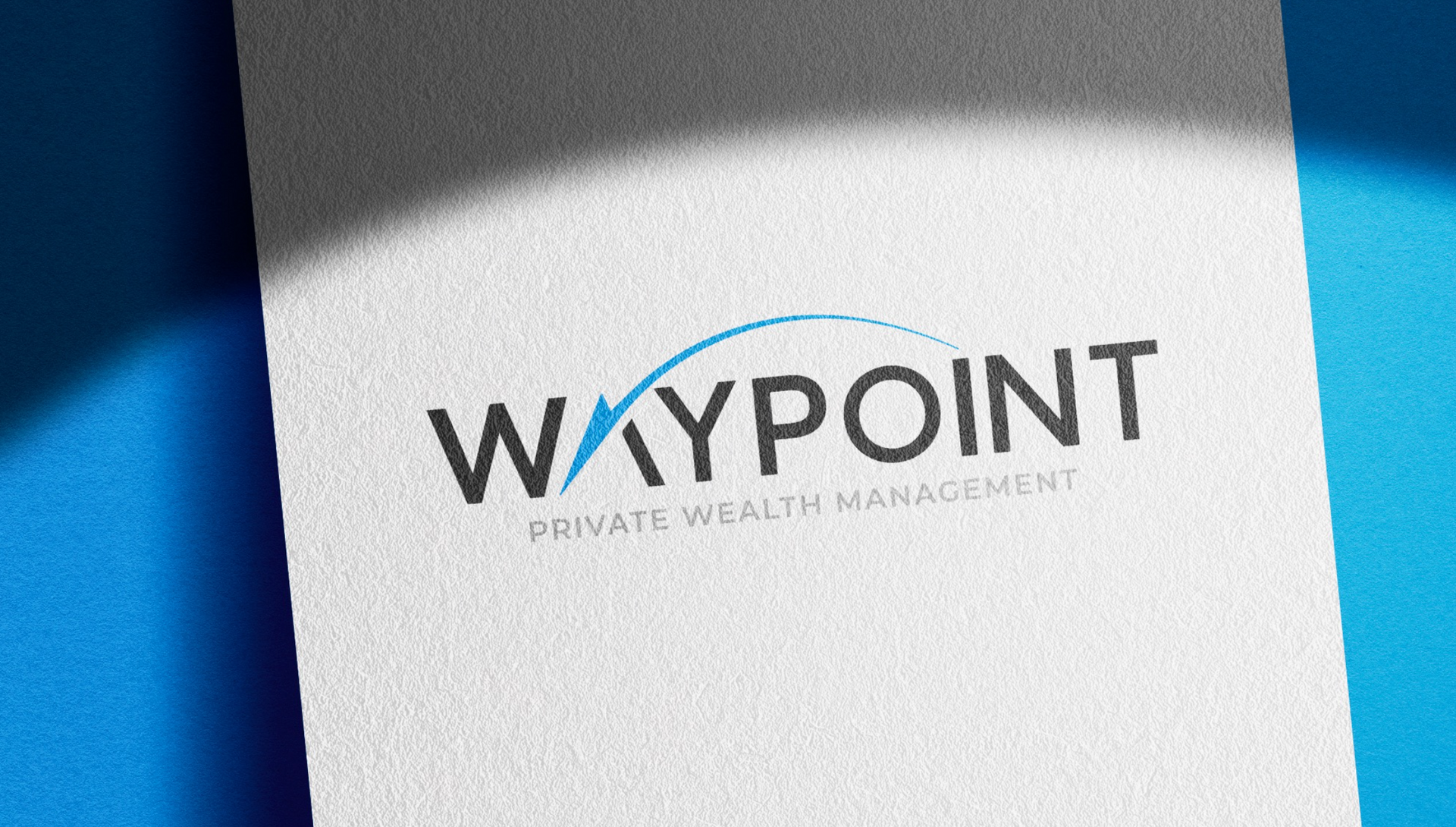 A waypoint logo is on a piece of paper on a blue surface.