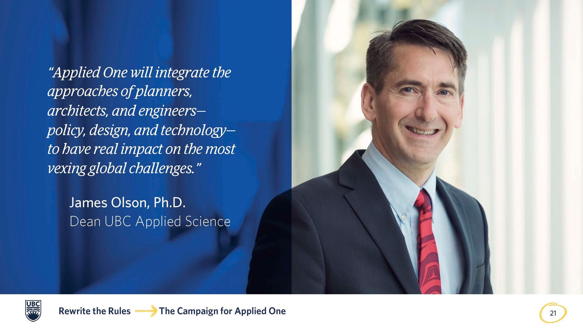 A man in a suit and tie is smiling in front of a quote.