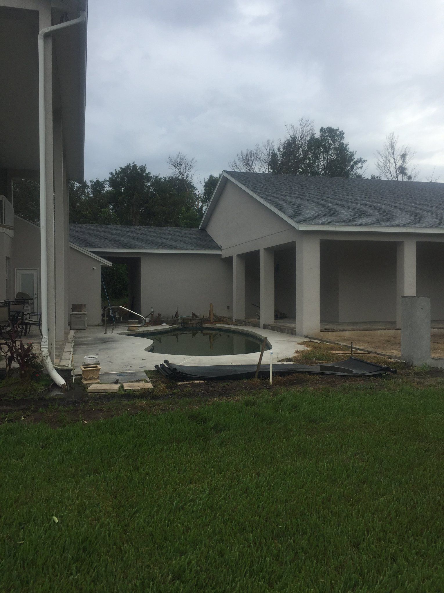A house under construction with a pool in the backyard.