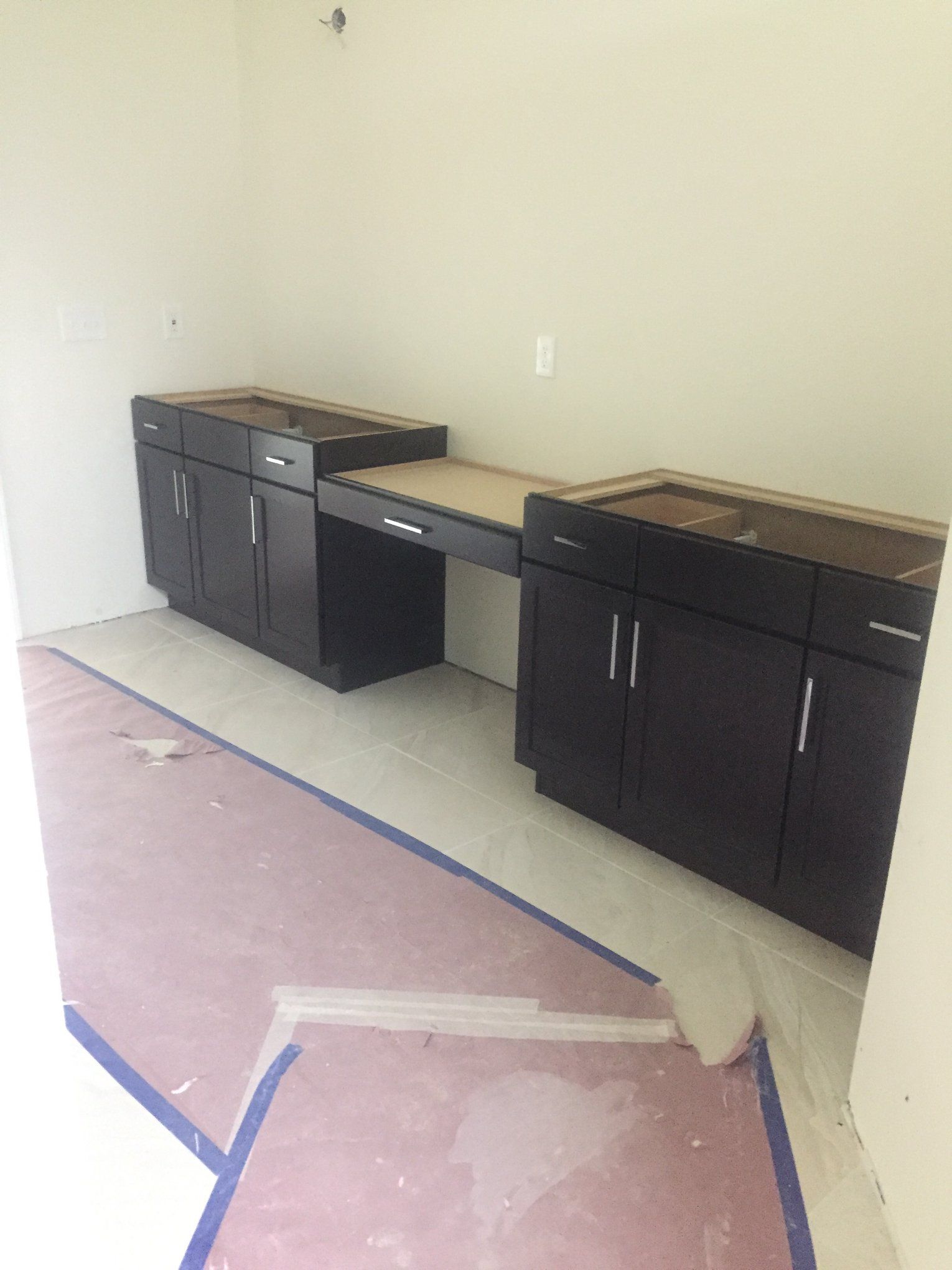 A room with cabinets and a desk in it