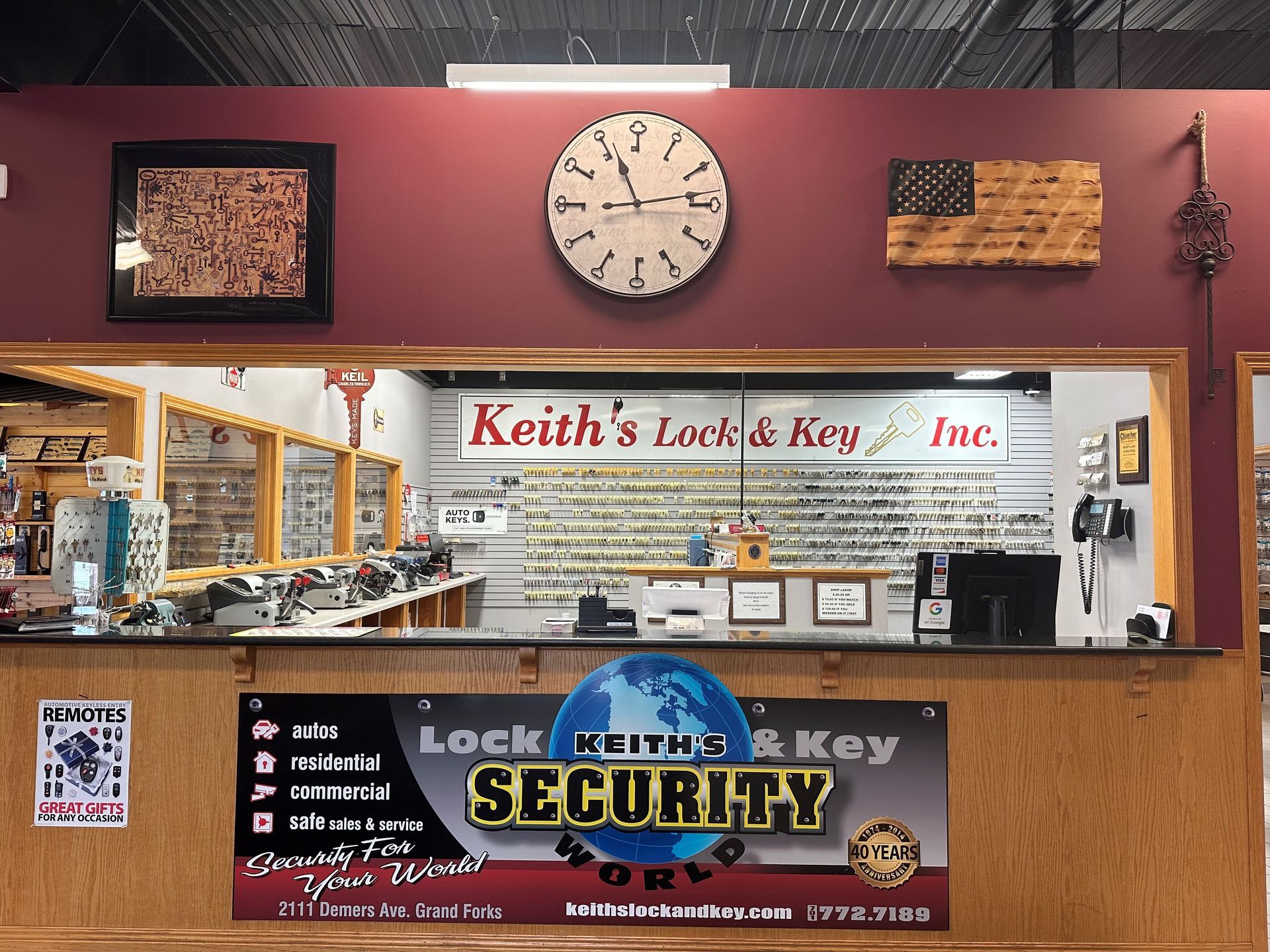 A clock hangs above the counter at keith 's lock & key inc.