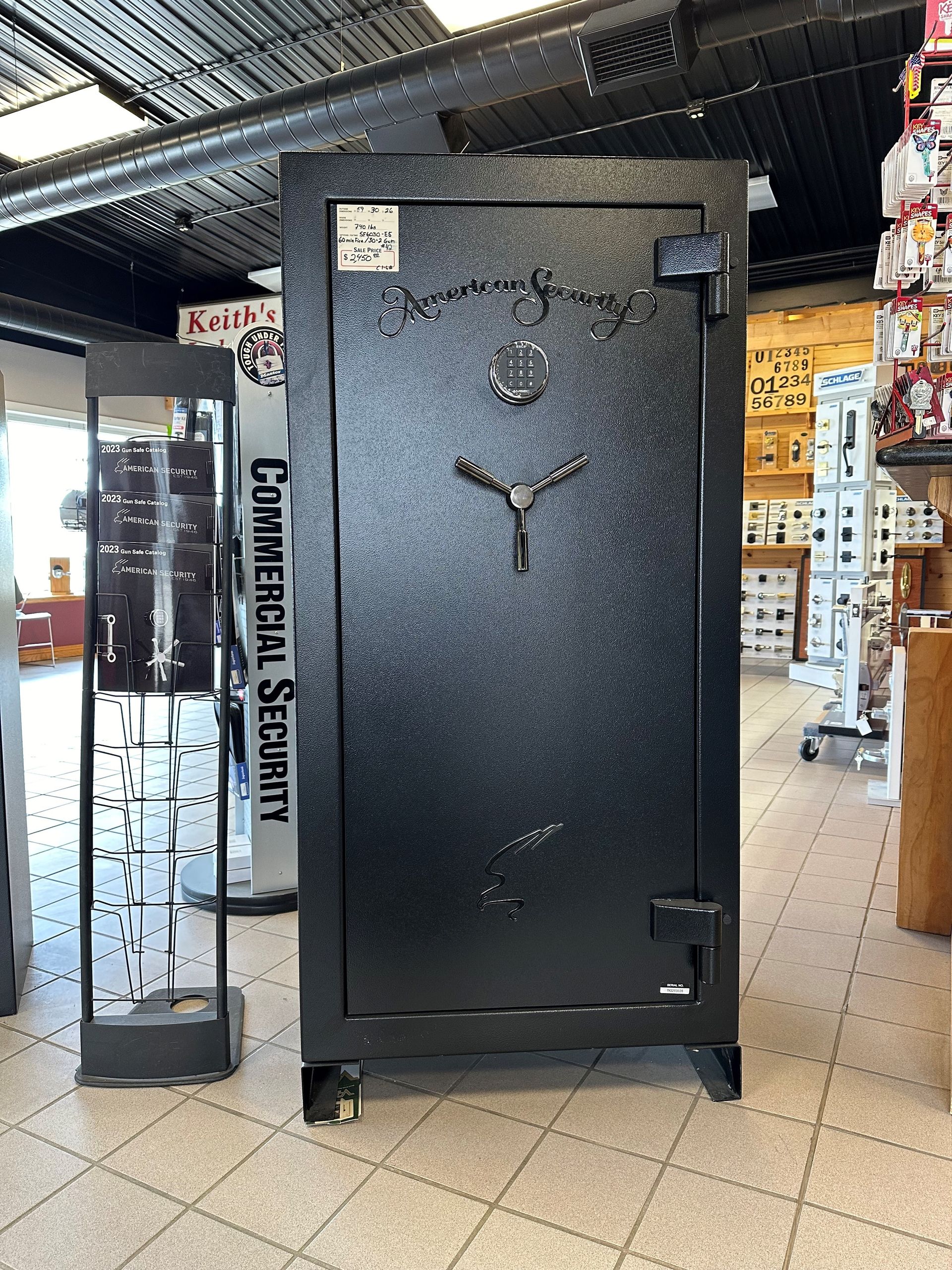 A large black safe is sitting in a store.