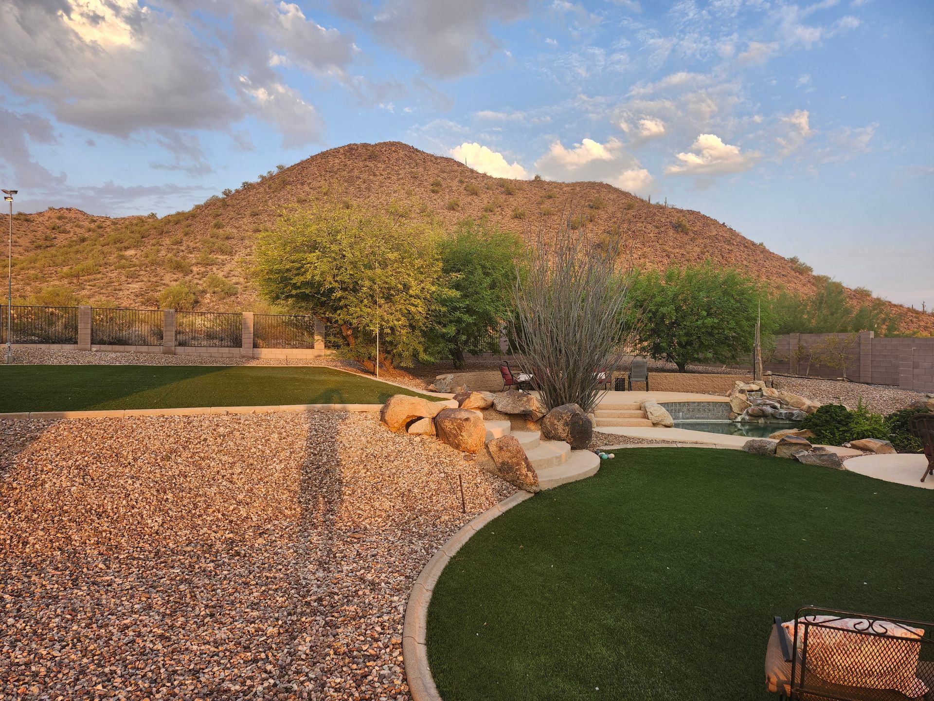 A large house with a fire pit in front of it.