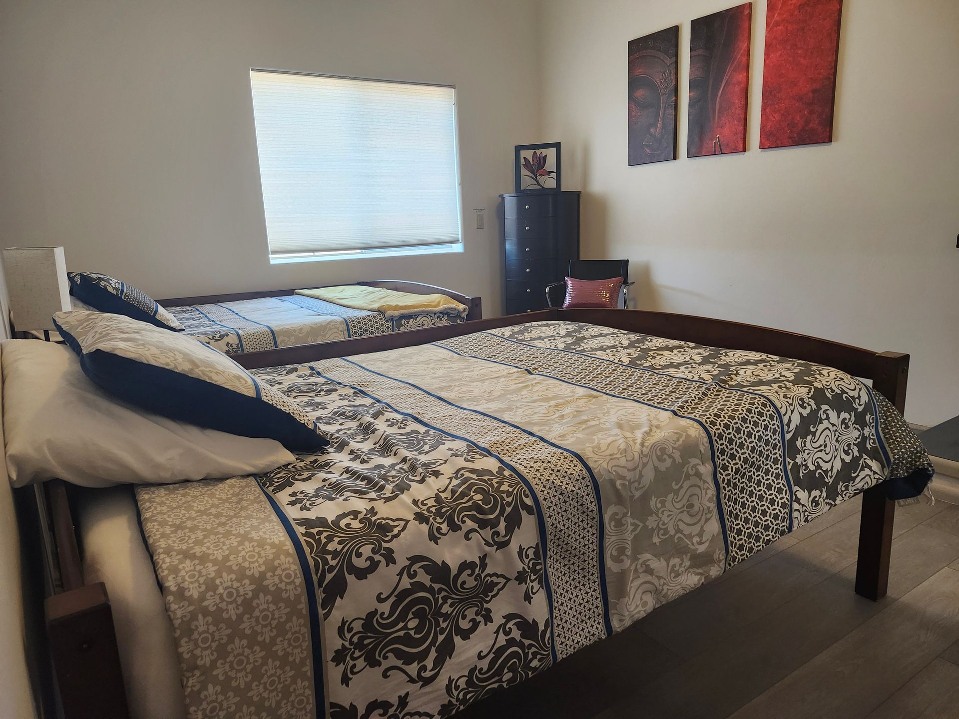 A bedroom with a bed , bunk beds and a ceiling fan.