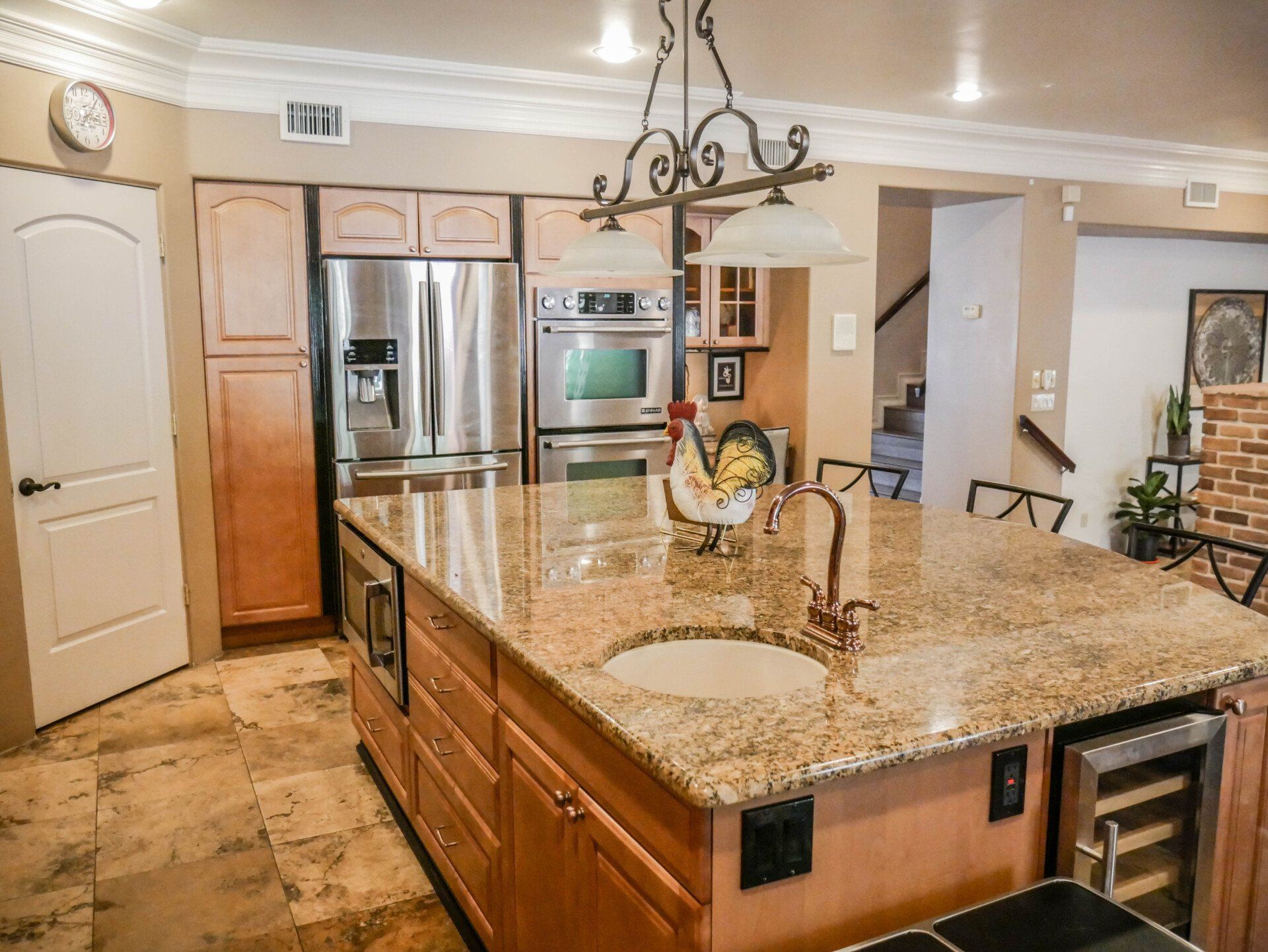 A kitchen with a large island and granite counter tops